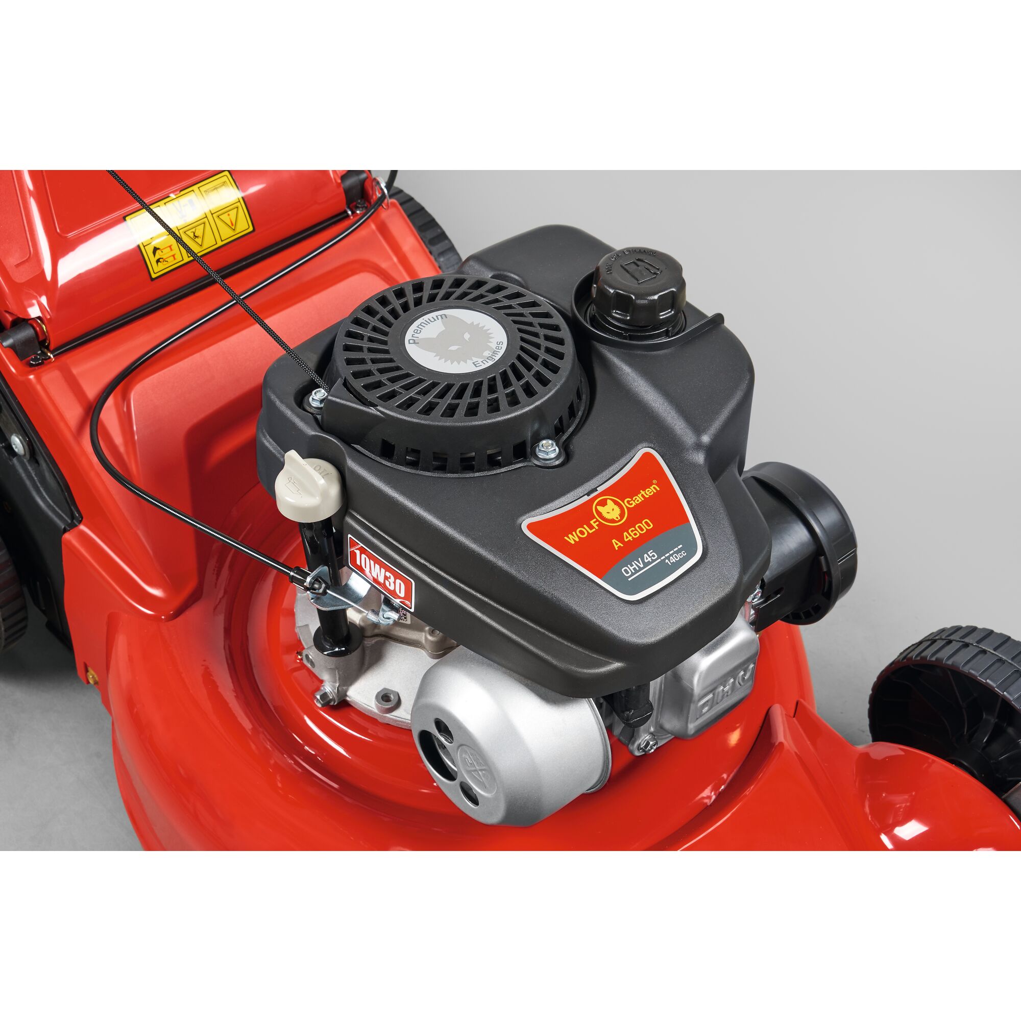 Close-up view of the engine compartment of a WOLF-Garten lawn mower, showing the model A600 with a red body and black engine housing.