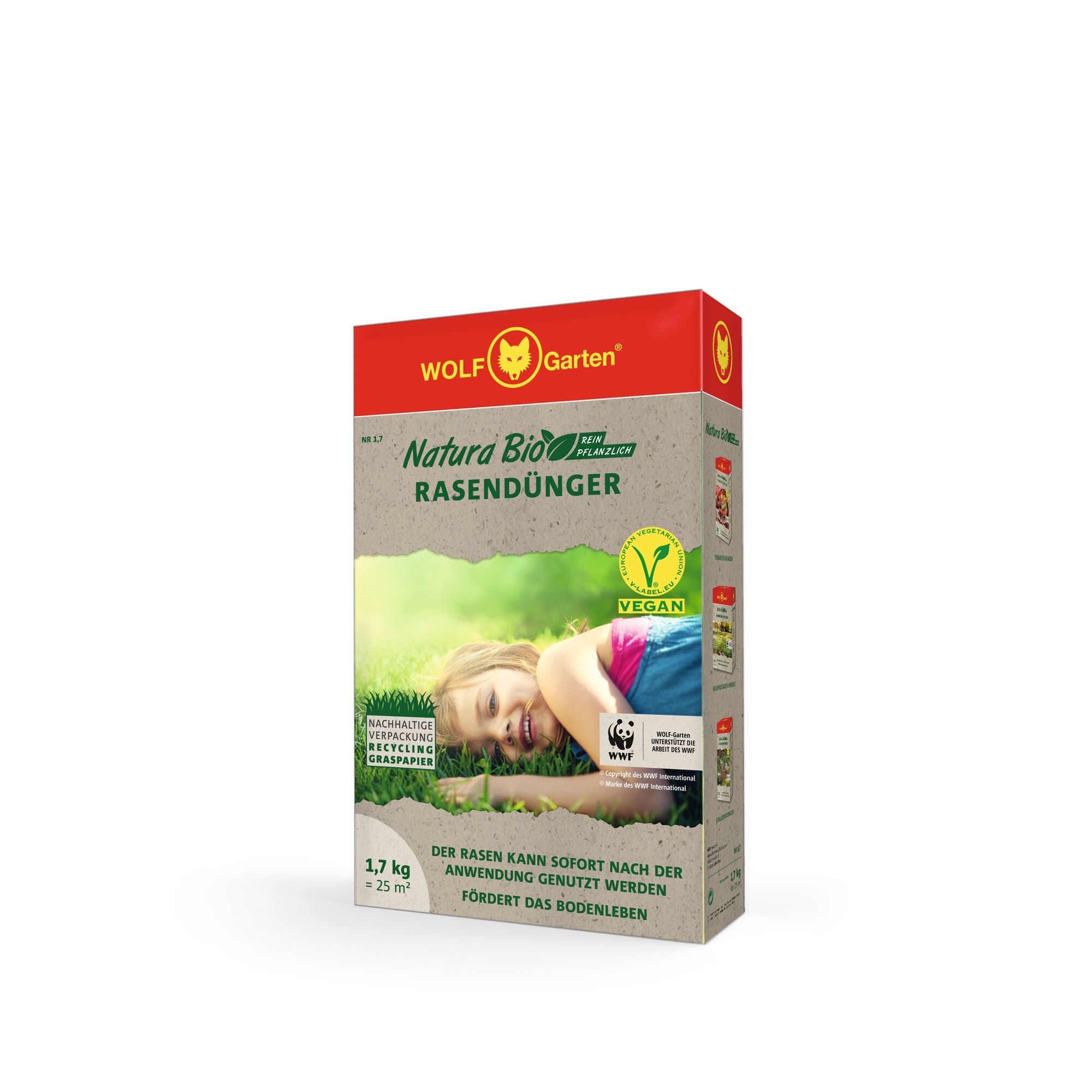 A rectangular box of WOLFGarten Natura Bio lawn fertilizer with vegan and sustainable packaging claims. The front shows a person lying on grass, product information in German, and partnership logos.