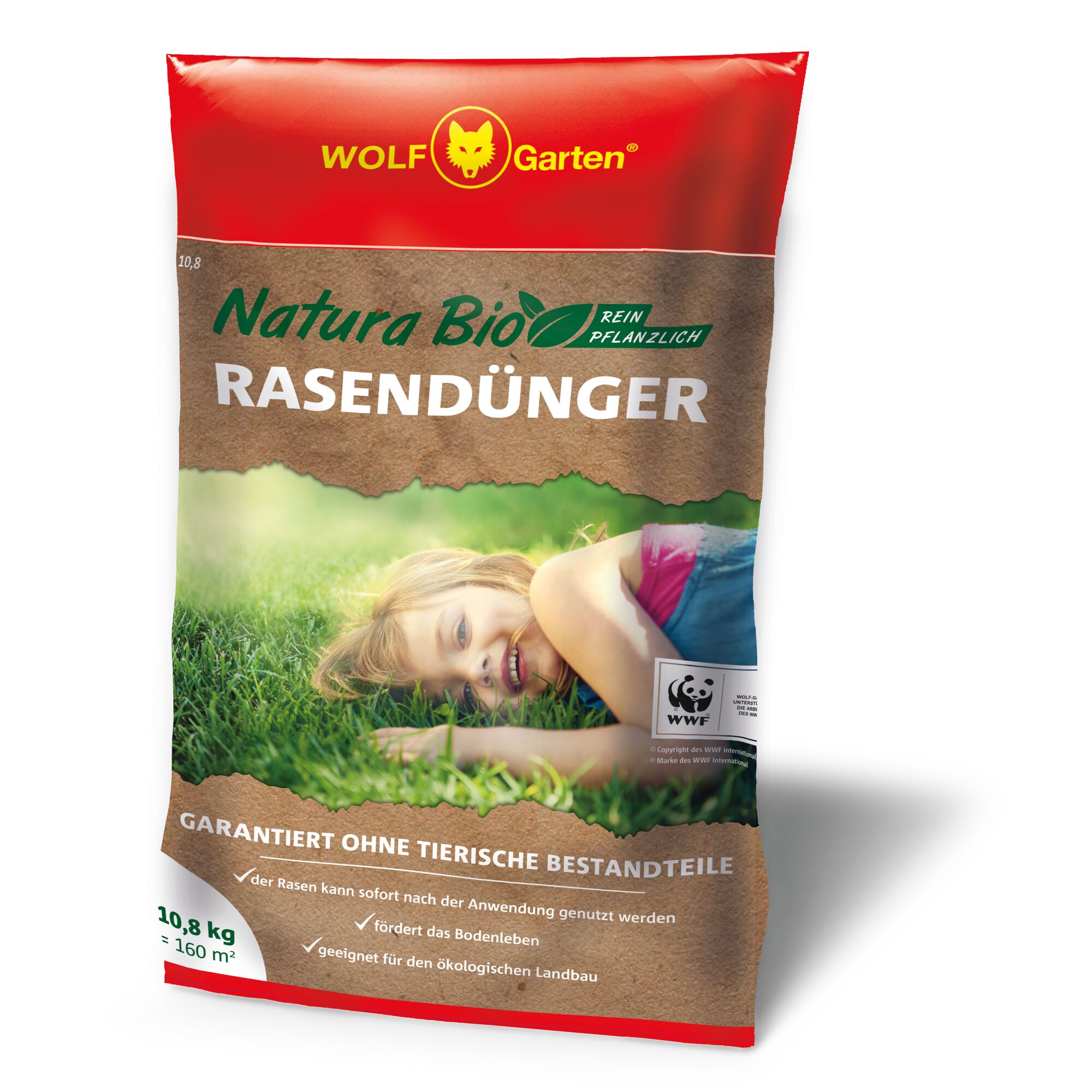 A bag of WOLF-Garten Natura Bio lawn fertilizer with a red and brown design, displaying product information and a green grass background with a person lying on the lawn. The packaging states that it is purely plant-based and free from animal components.