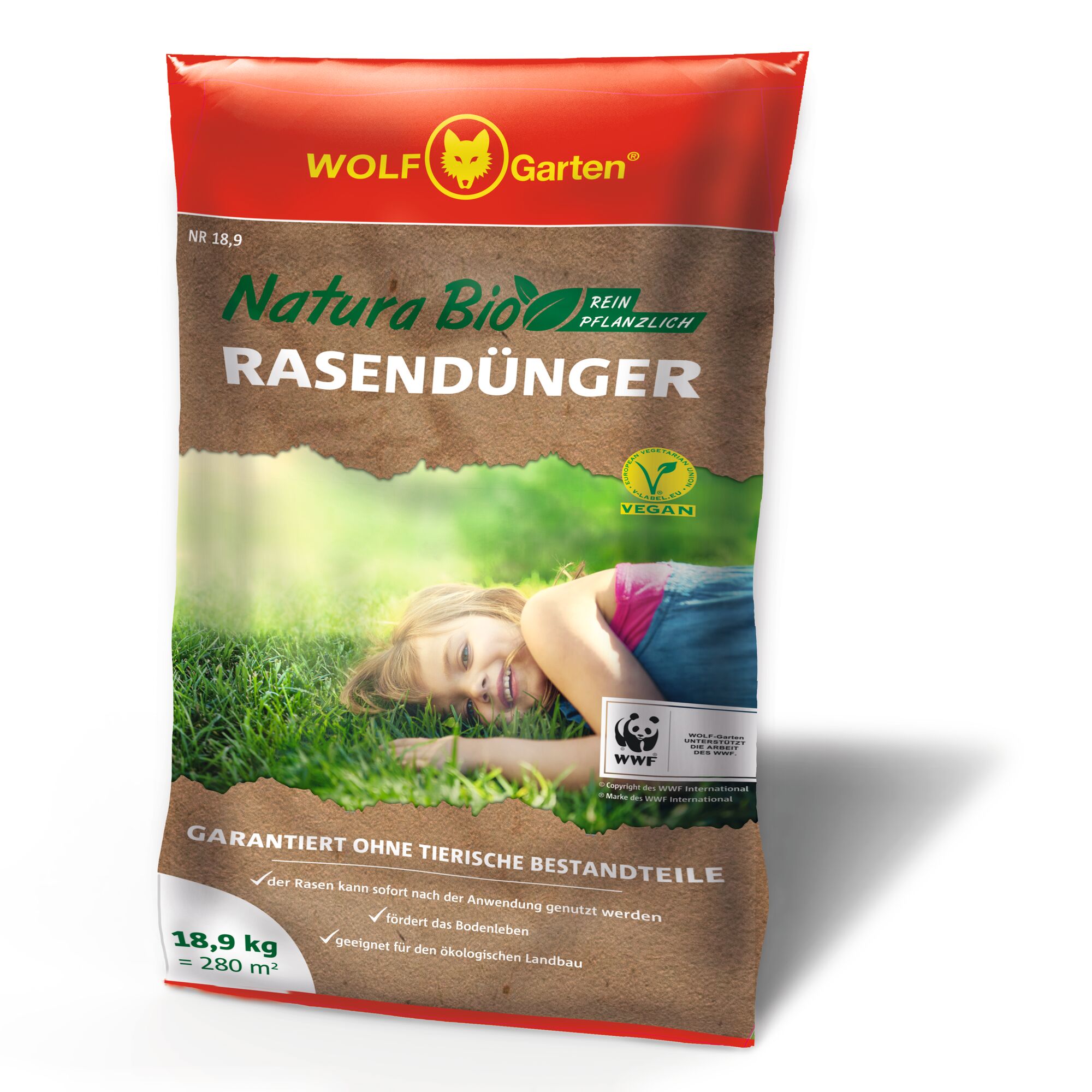 A bag of WOLF-Garten Natura Bio lawn fertilizer. The packaging is red and brown, with green accents, and displays 'RASENDÜNGER' prominently. It shows a person lying on green grass. The bag includes a vegan logo and WWF partnership, mentions 'Guaranteed without animal components', and states coverage for 18.9kg (280m²).