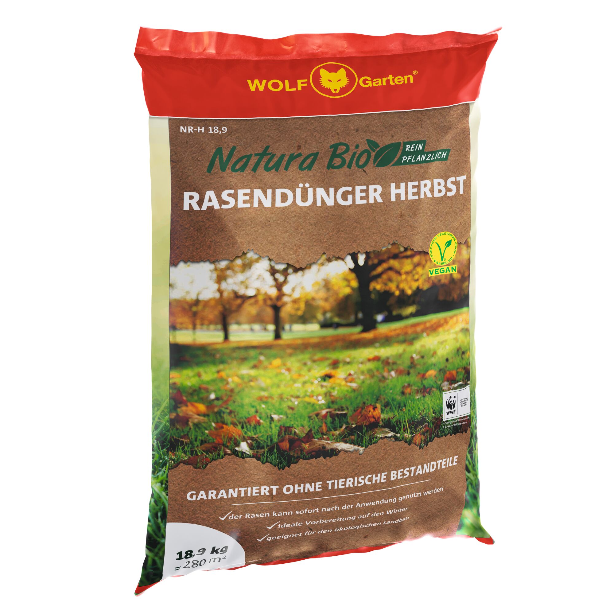A bag of WOLF Garten Natura Bio autumn lawn fertilizer. The packaging is mostly brown and red with a picture of a grassy lawn covered in autumn leaves, and trees in the background. The label indicates the product is vegan, plant-based, intended for autumn use, and contains 18.9 kg for coverage of 280 square meters.