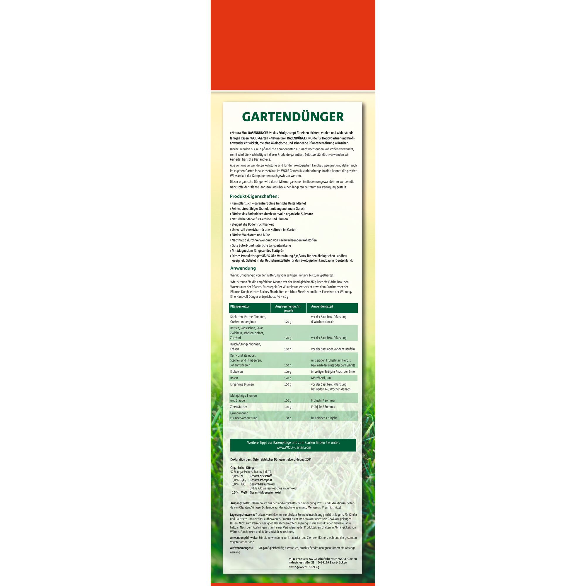 Image of a WOLF-Garten product packaging with a primarily red and green design. The product is 'Gartendünger', a garden fertilizer. The front of the package contains detailed information in German, including product features, instructions for use, dosage guidelines for various plants, and contact details. The text is organized into sections with bold headings and a table for application rates, with a blurred grass background at the bottom.
