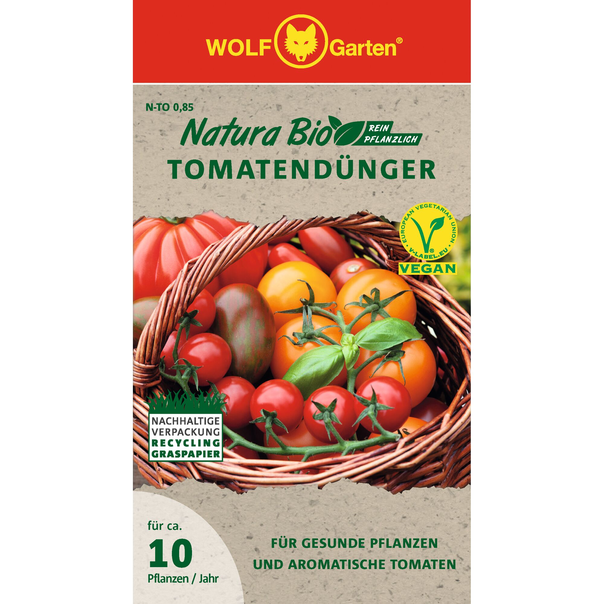 Front packaging of WOLF Garten Natura Bio Tomato Fertilizer. The design shows a basket filled with various fresh tomatoes, and includes icons such as 'Vegan' and 'Sustainable packaging recycling grass paper'. Text highlights that it is plant-based and suitable for healthy plants and aromatic tomatoes for around 10 plants per year.