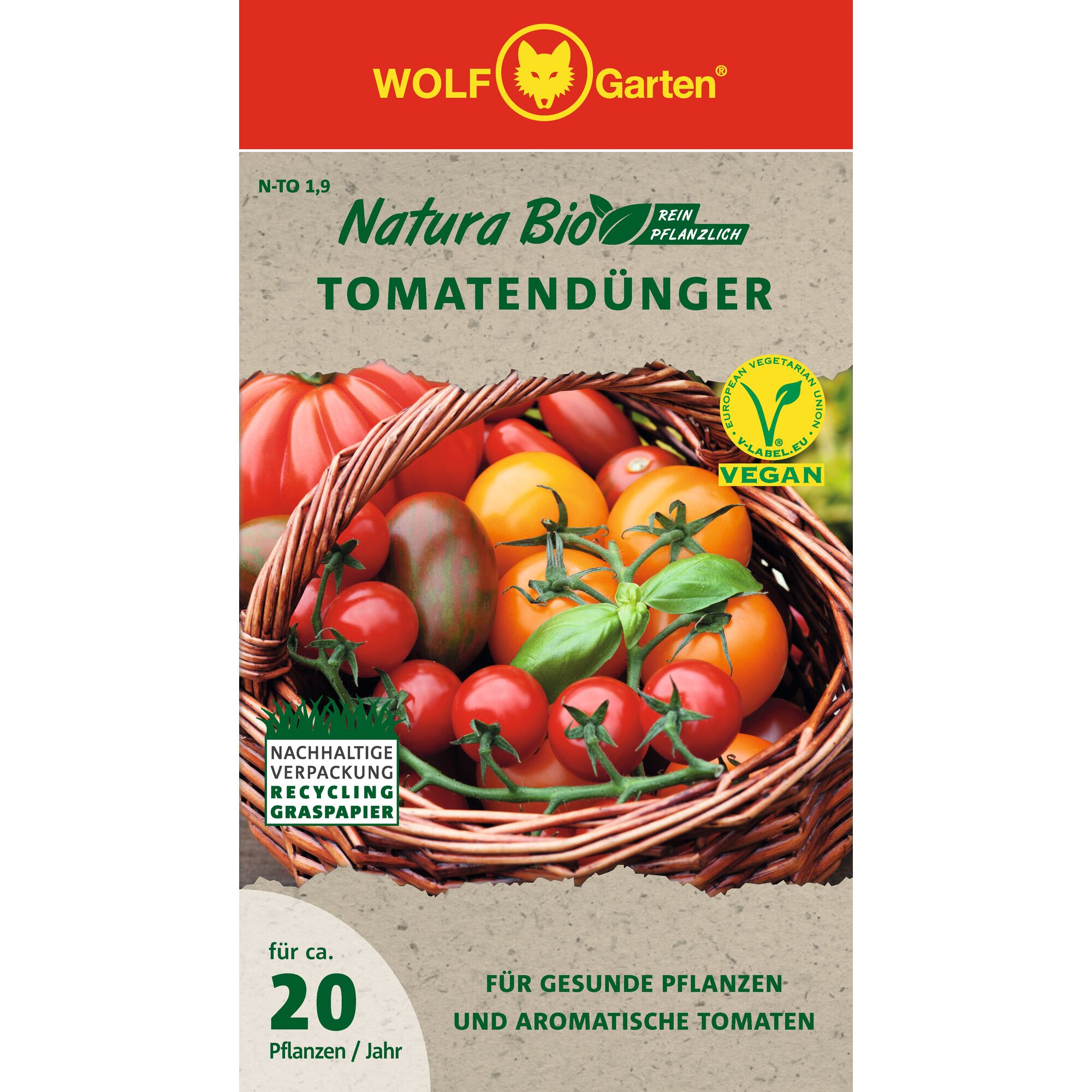 Front packaging of WOLF Garten Natura Bio Tomato Fertilizer. The design features a basket filled with various tomatoes, along with several labels indicating the product is vegan and uses sustainable packaging made from recycled grass paper. The text highlights that the fertilizer promotes healthy plants and aromatic tomatoes, and is intended for approximately 20 plants per year.
