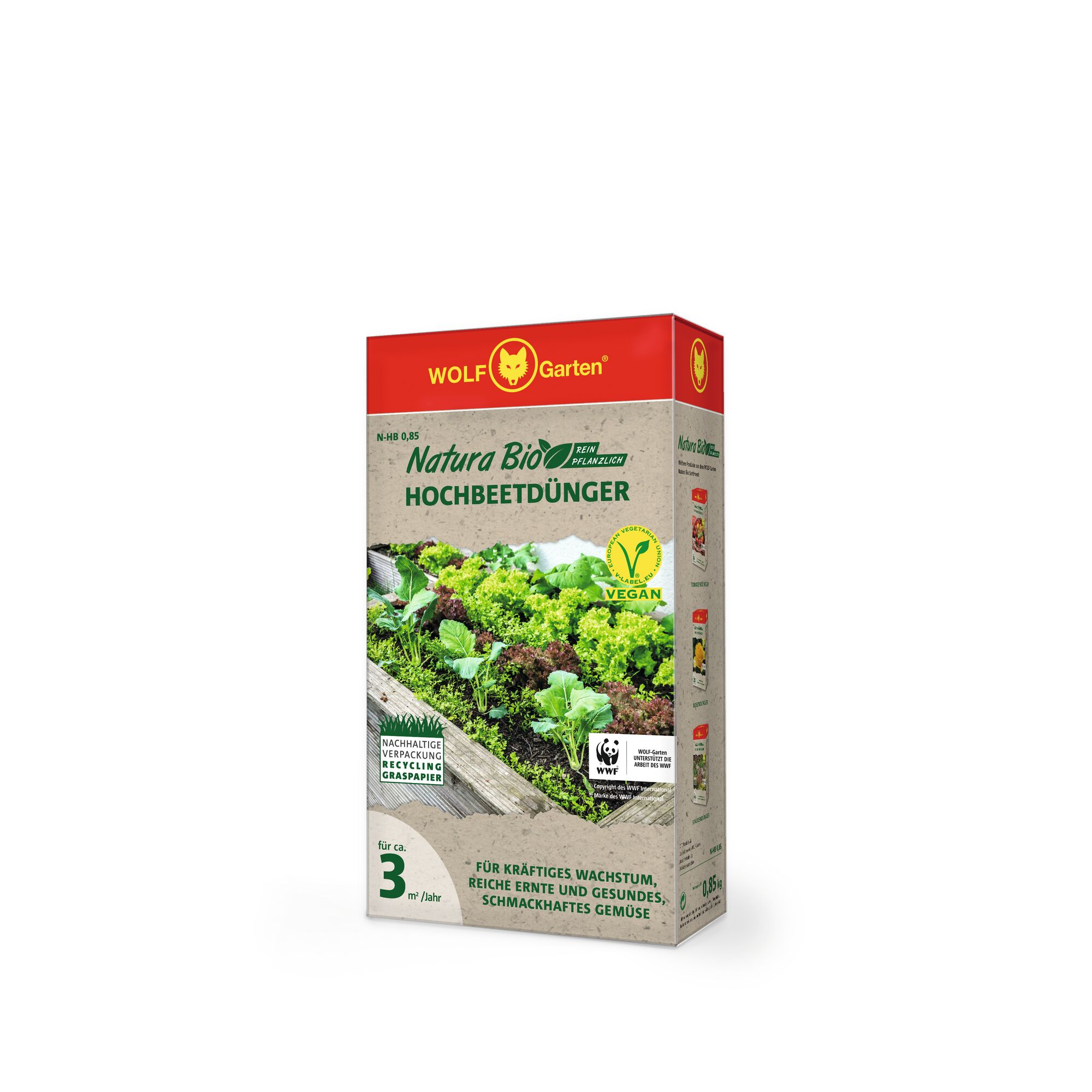 A box of WOLFGarten Natura Bio Hochbeetdünger, a vegan, organic raised bed fertilizer, featuring a picture of leafy green vegetables growing in a raised garden bed on the front. The packaging has a red top with the WOLFGarten logo and includes labels for sustainable packaging and vegan certification.
