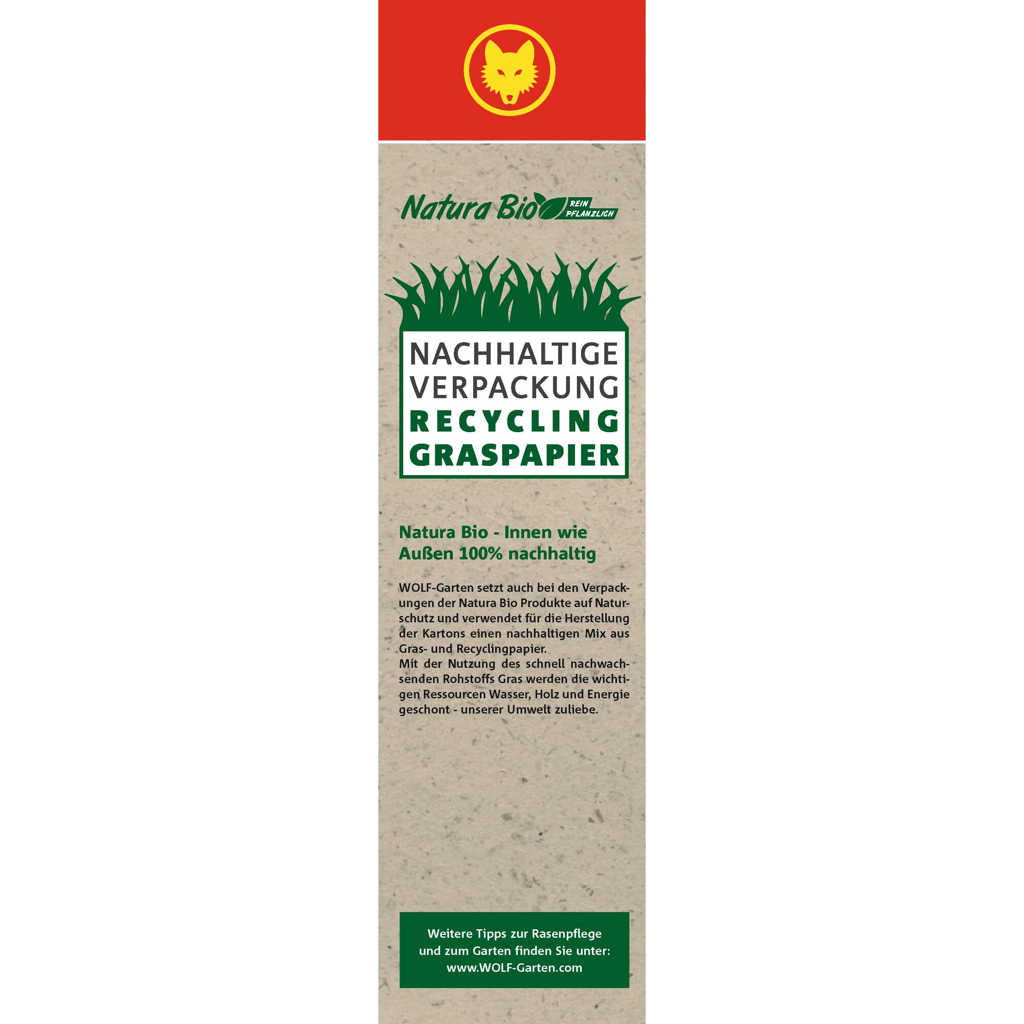 Tall vertical packaging label for WOLF-Garten Natura Bio, featuring sustainable packaging made from recycled grass paper. The design shows a red section with a yellow wolf logo at the top, green grass illustrations and text stating 'Sustainable packaging, Recycling, Grass paper.' Additional environmental information and website details are included in German.
