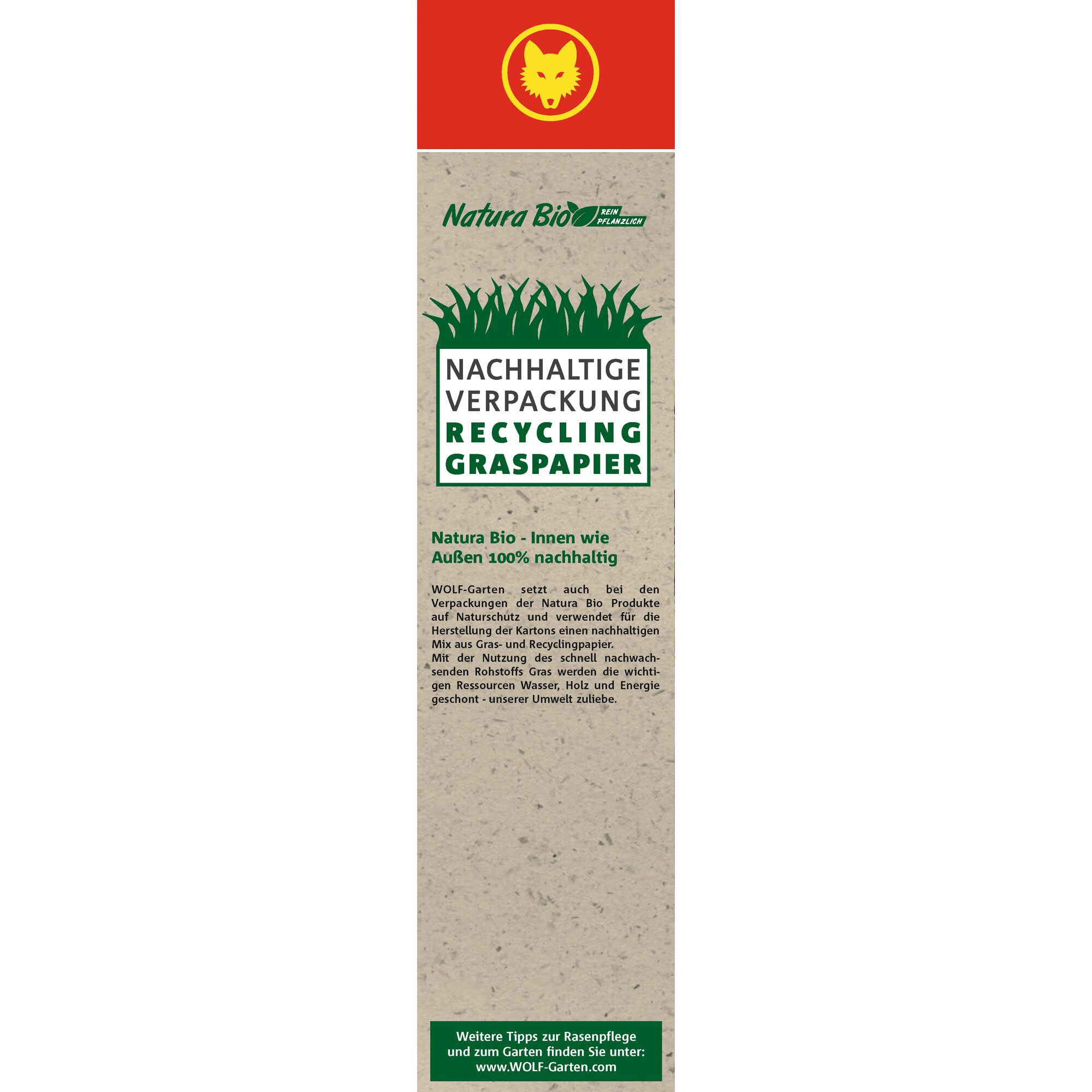 Vertical label for WOLFGarten Natura Bio, highlighting sustainable packaging made from recycled grass paper. The design includes a red background with a yellow wolf head, green text and graphics about eco-friendly packaging, and informational text explaining the use of grass and recycled material in the packaging.