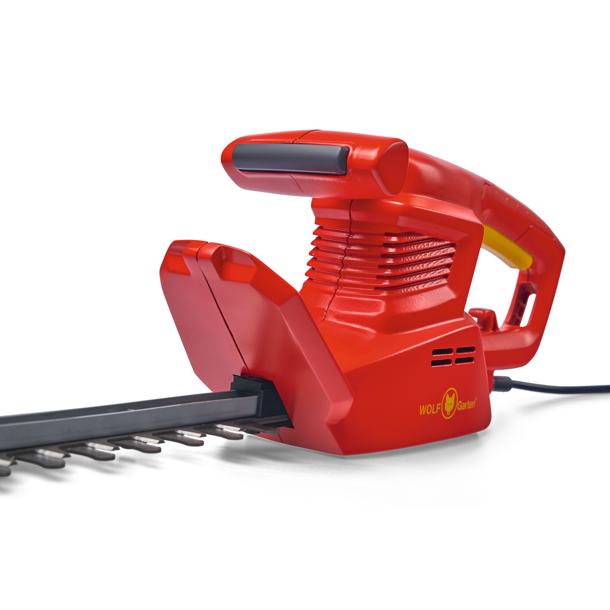 Close-up view of a red WOLF Garten electric hedge trimmer with a black blade and ergonomic handle, designed for garden maintenance.