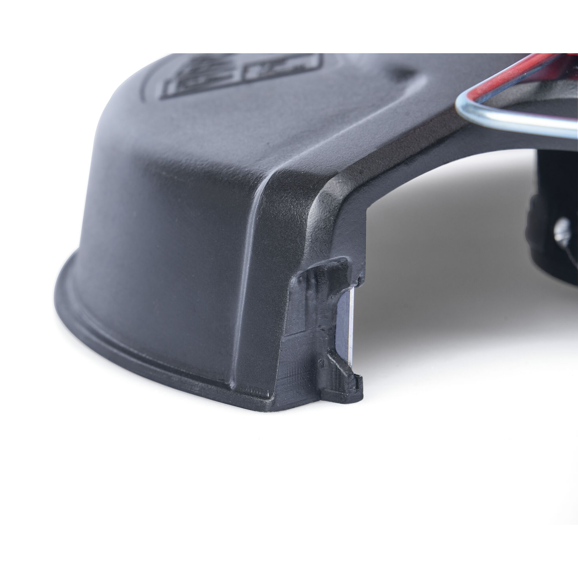 Close-up image of a black plastic protective cover, featuring a cutout section and part of a metal wire on a white background.