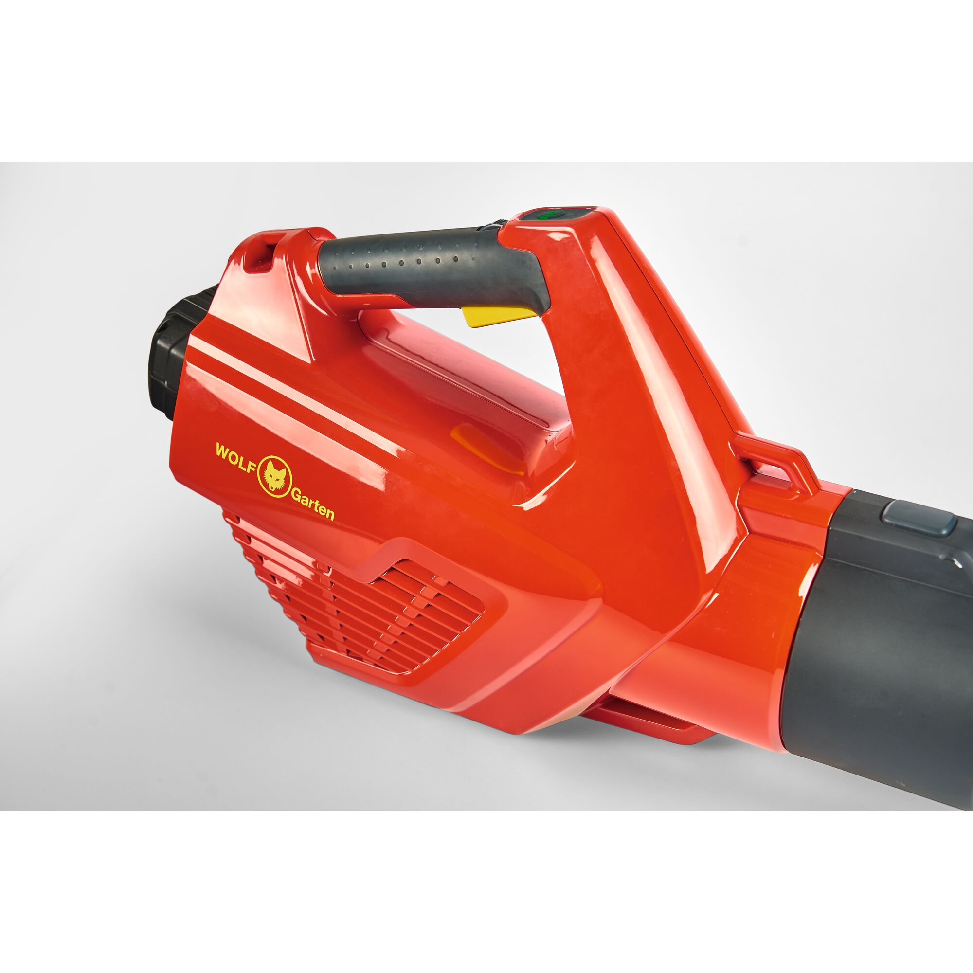 Close-up of a red WOLF Garten leaf blower with a black handle and visible logo, photographed against a plain white background.