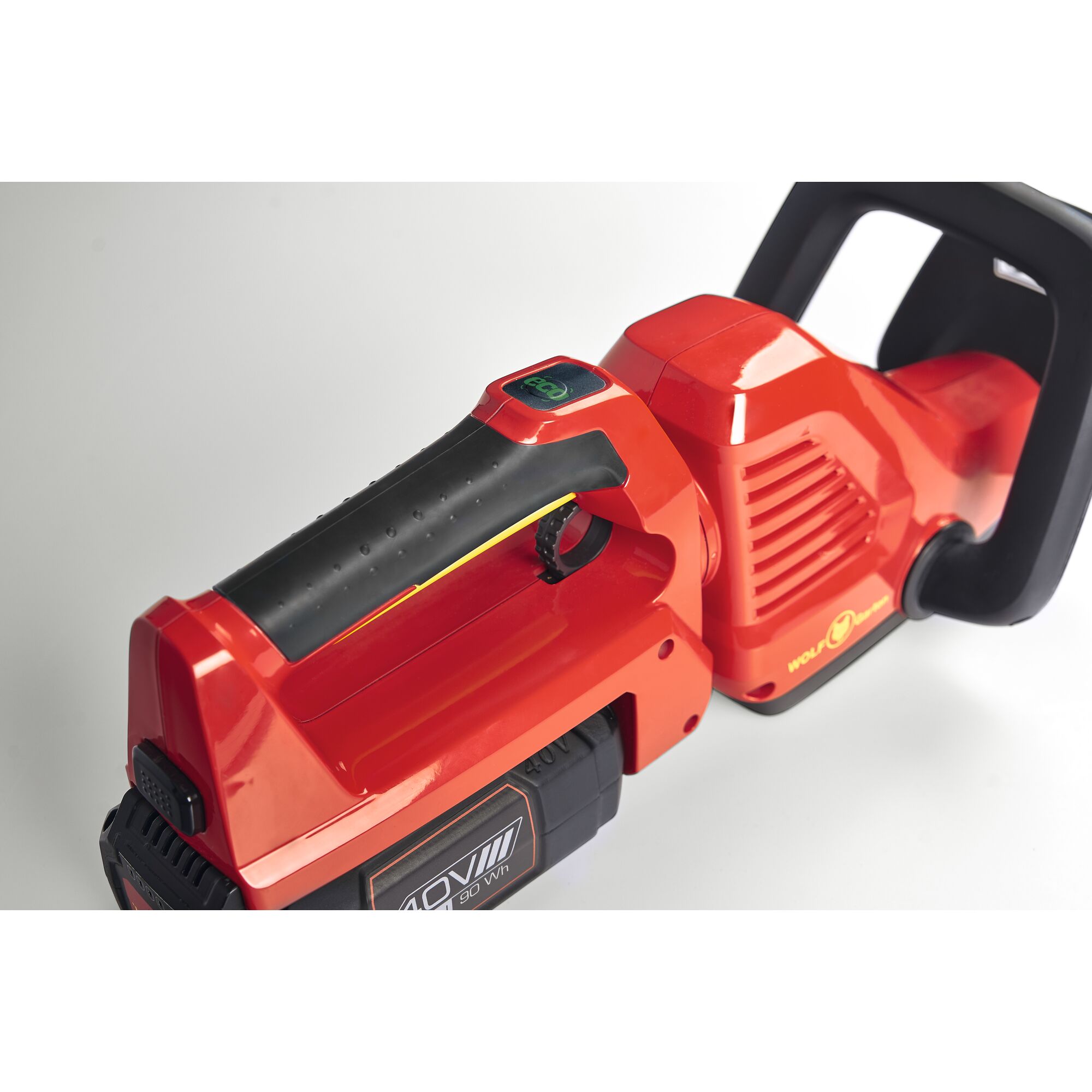 Close-up view of a red and black electric garden tool, showing the handle, battery compartment labeled '40V', and part of the body with the WOLFGarten logo.