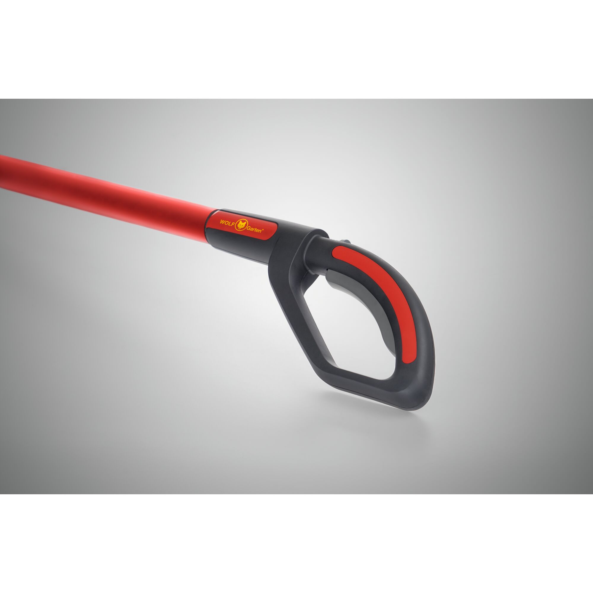Close-up image of a red and black gardening tool handle with an ergonomic grip and a WOLFGarten logo.