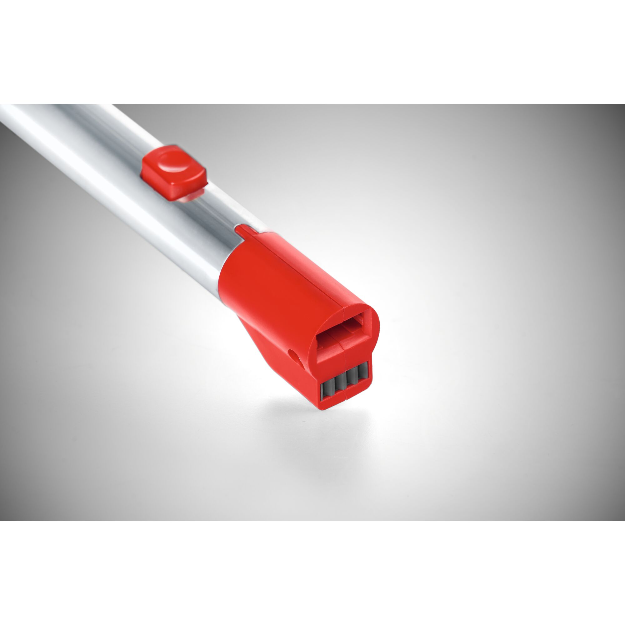 Close-up view of a WOLFGarten interchangeable tool handle with a metallic shaft and a red plastic connector, designed for use with compatible garden tool heads.