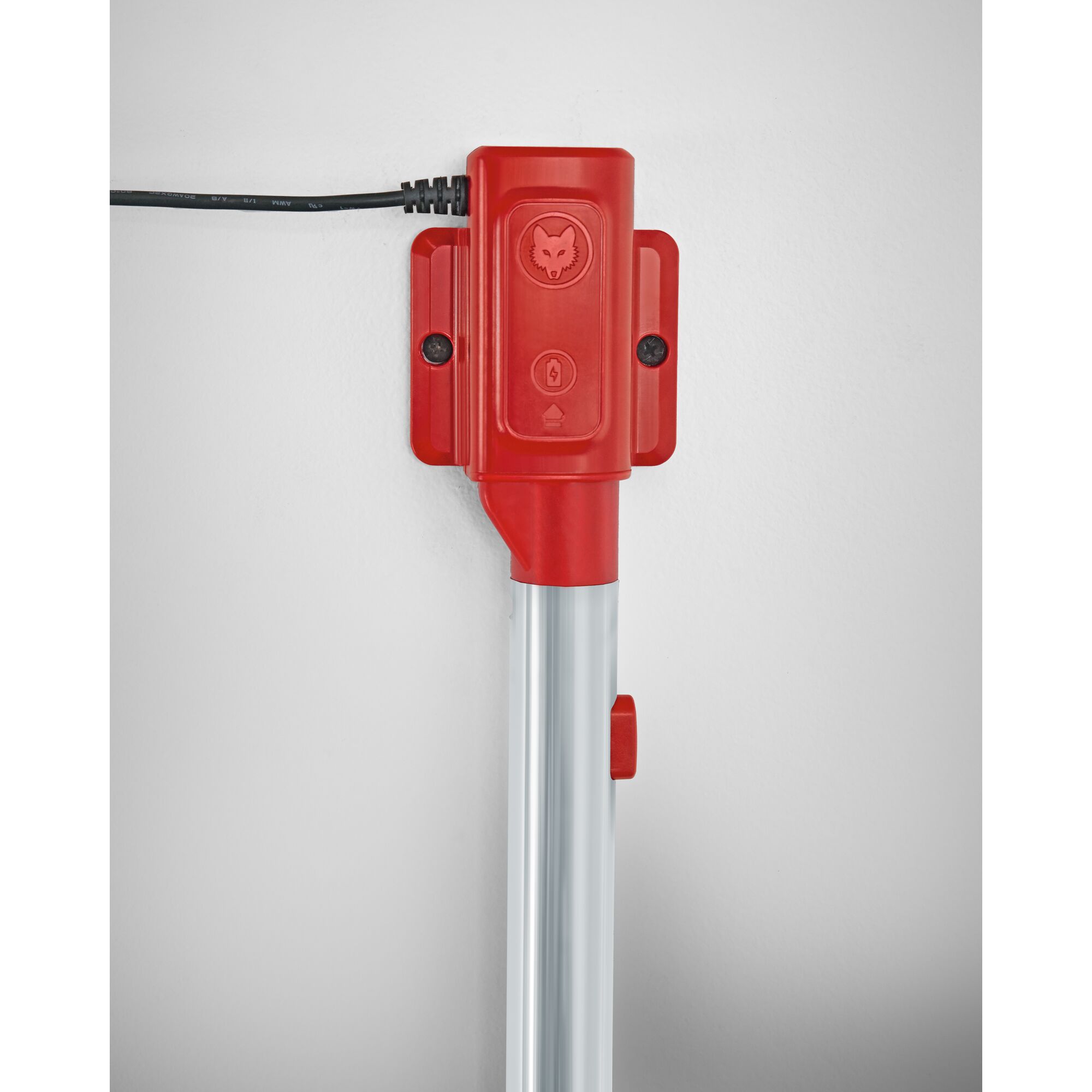 Close-up of a WOLFGarten product showing a red and silver handle with a red electronic control unit attached, featuring a cable connected at the top and the wolf logo and buttons on the unit.