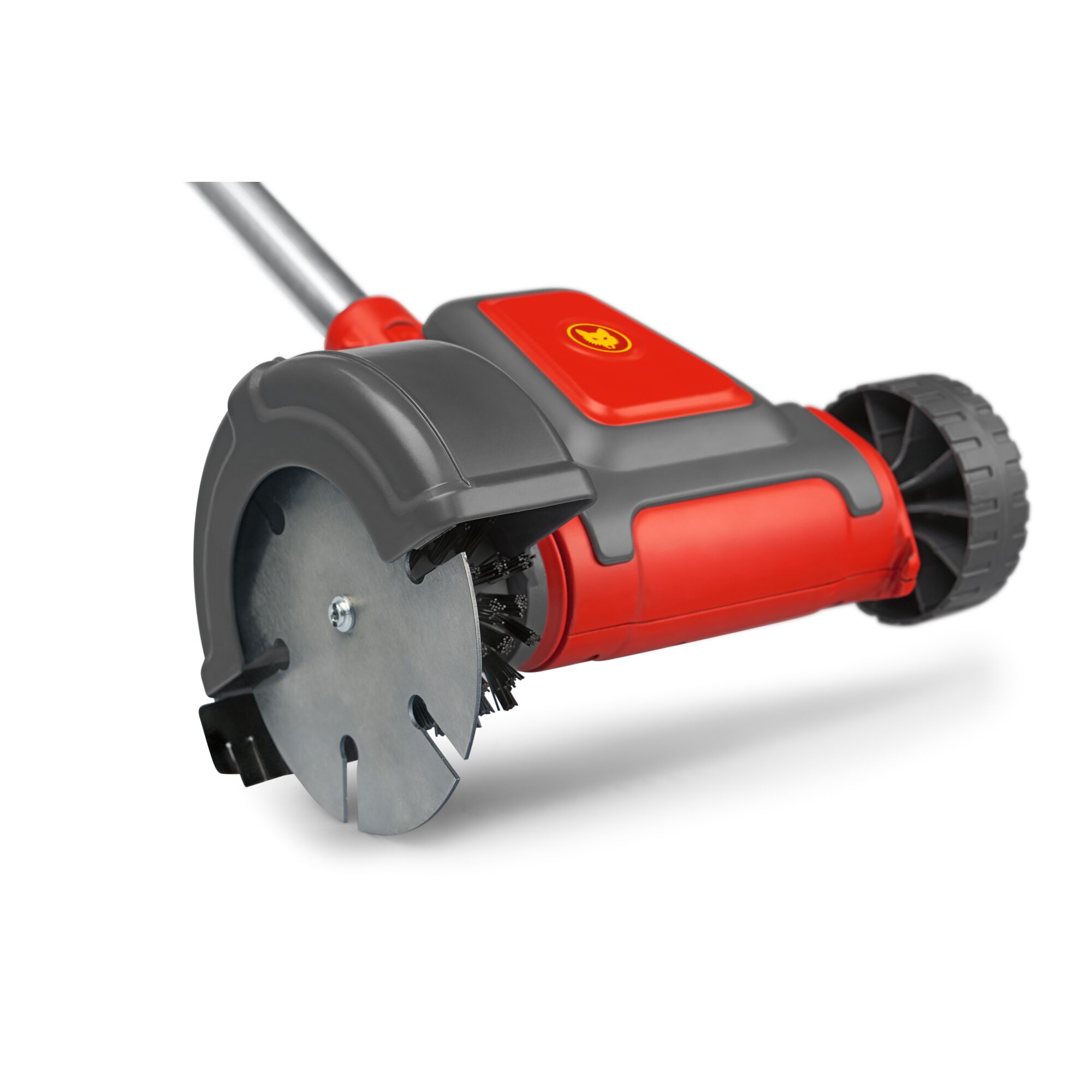 Close-up of a WOLFGarten garden tool with a metal blade, red and black casing, a wheel, and a handle, designed for cleaning and maintaining outdoor surfaces.