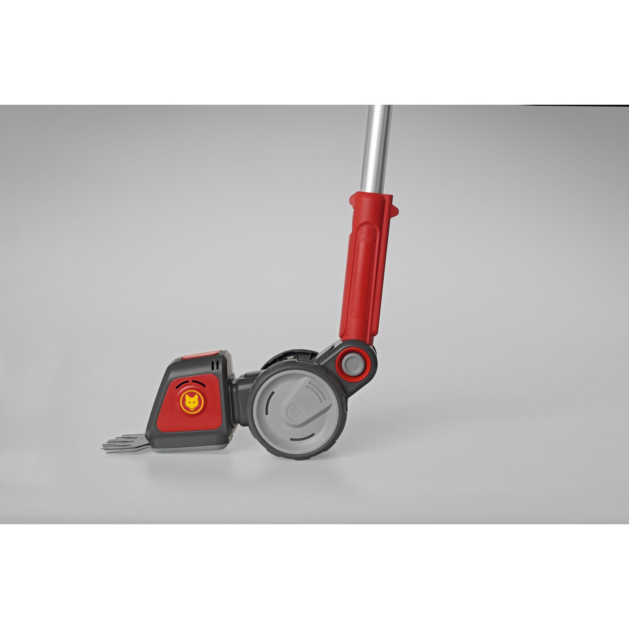 Close-up of a WOLFGarten garden tool with a grey and red handle and a wheel, suitable for outdoor gardening tasks.