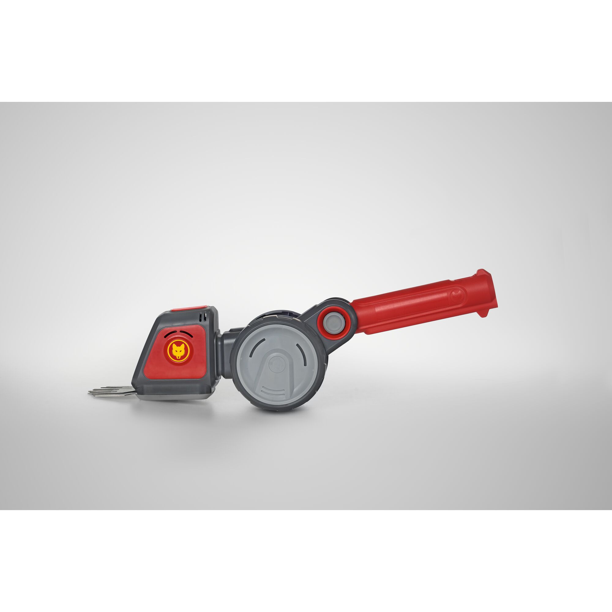A WOLFGarten garden tool with a red and gray handle, featuring a rotating mechanism and metal blades, photographed against a plain light background.