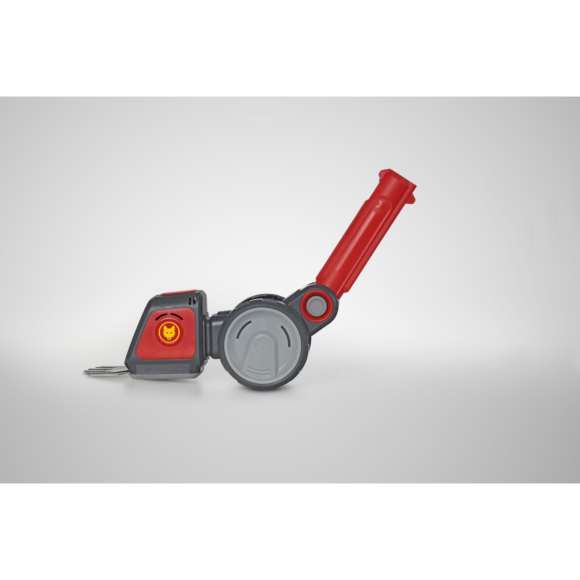 A close-up photograph of a WOLFGarten garden tool featuring a red and grey handle with a metal blade, positioned against a plain, light background.