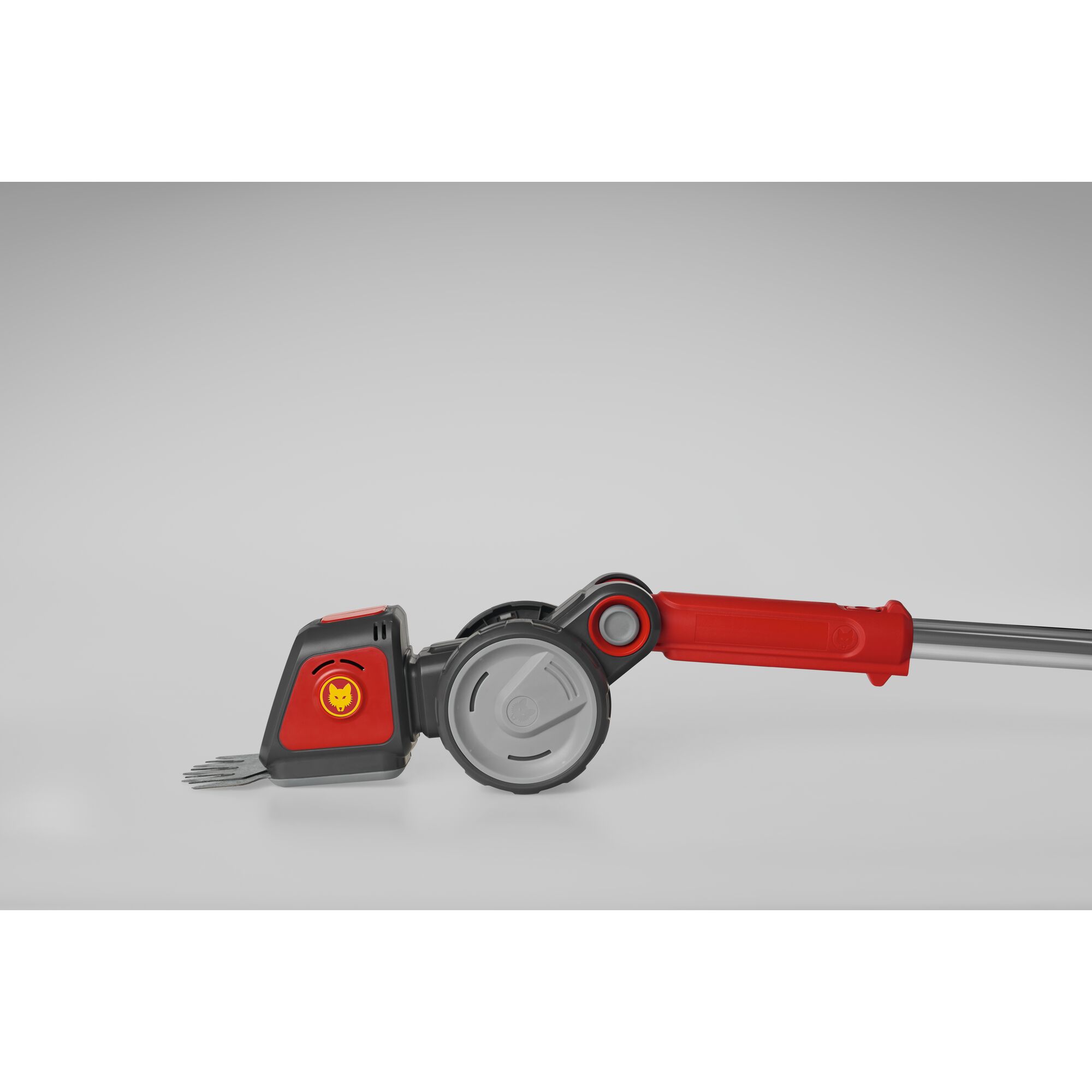 A WOLFGarten garden tool featuring a red and grey handle, a metallic wheel mechanism, and a forked attachment on a light grey background.