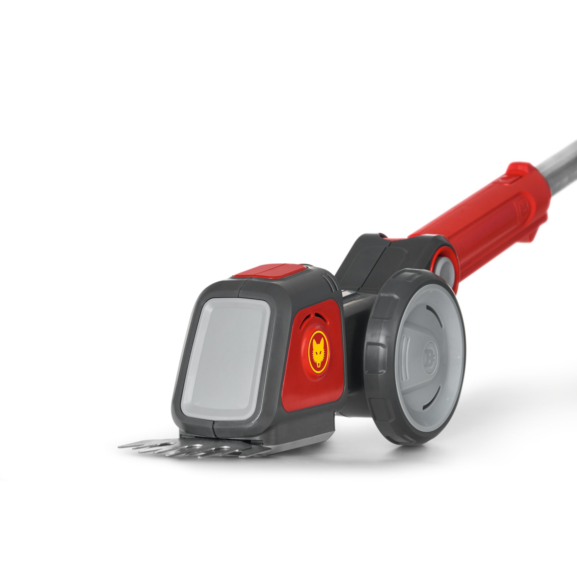 Close-up view of a WOLFGarten garden tool, featuring a red and grey handheld device with wheels and metal blades on the front, designed for trimming or cutting grass.