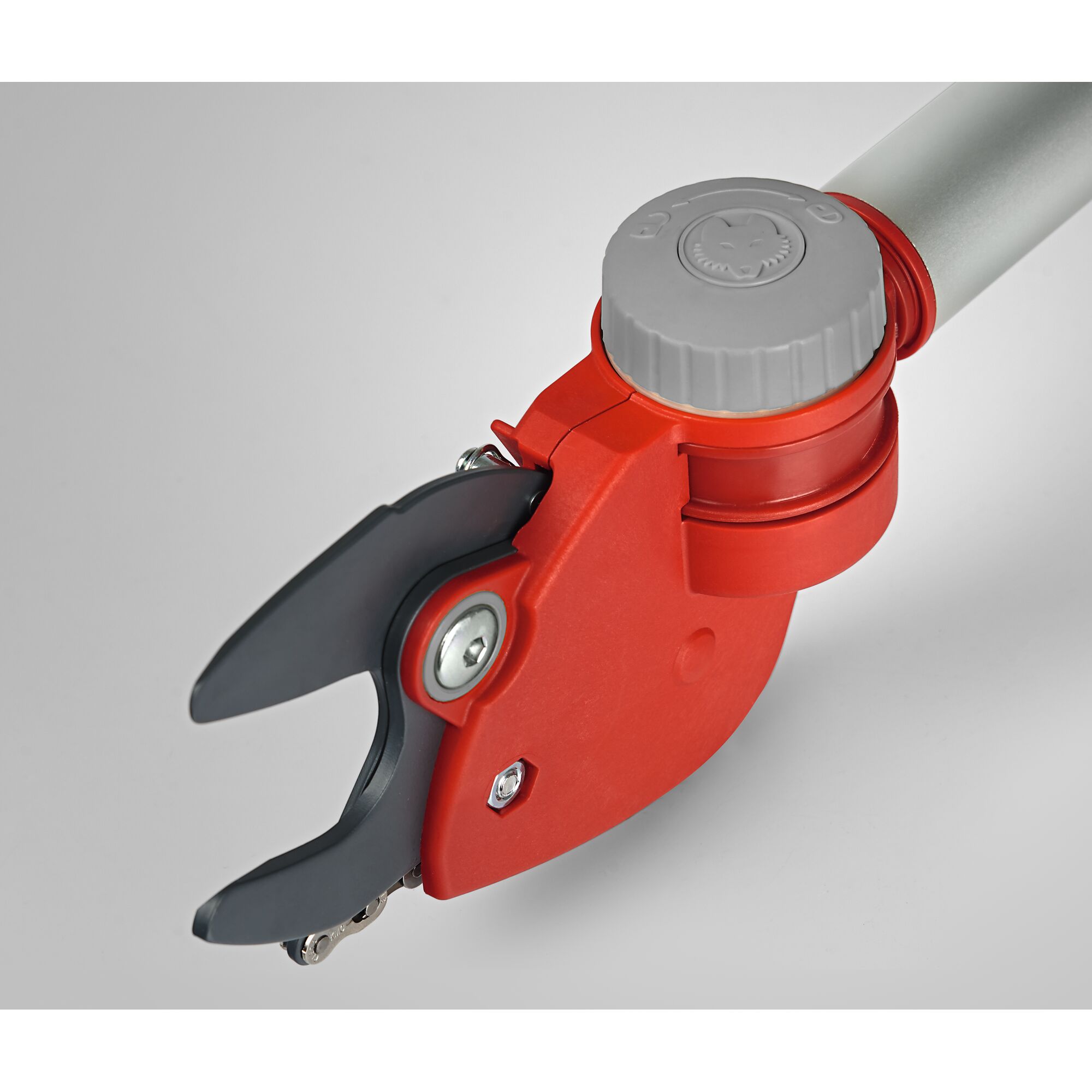 Close-up view of a WOLFGarten garden pruner with a red and gray handle and sharp black blades, designed for precise cutting in gardening tasks.