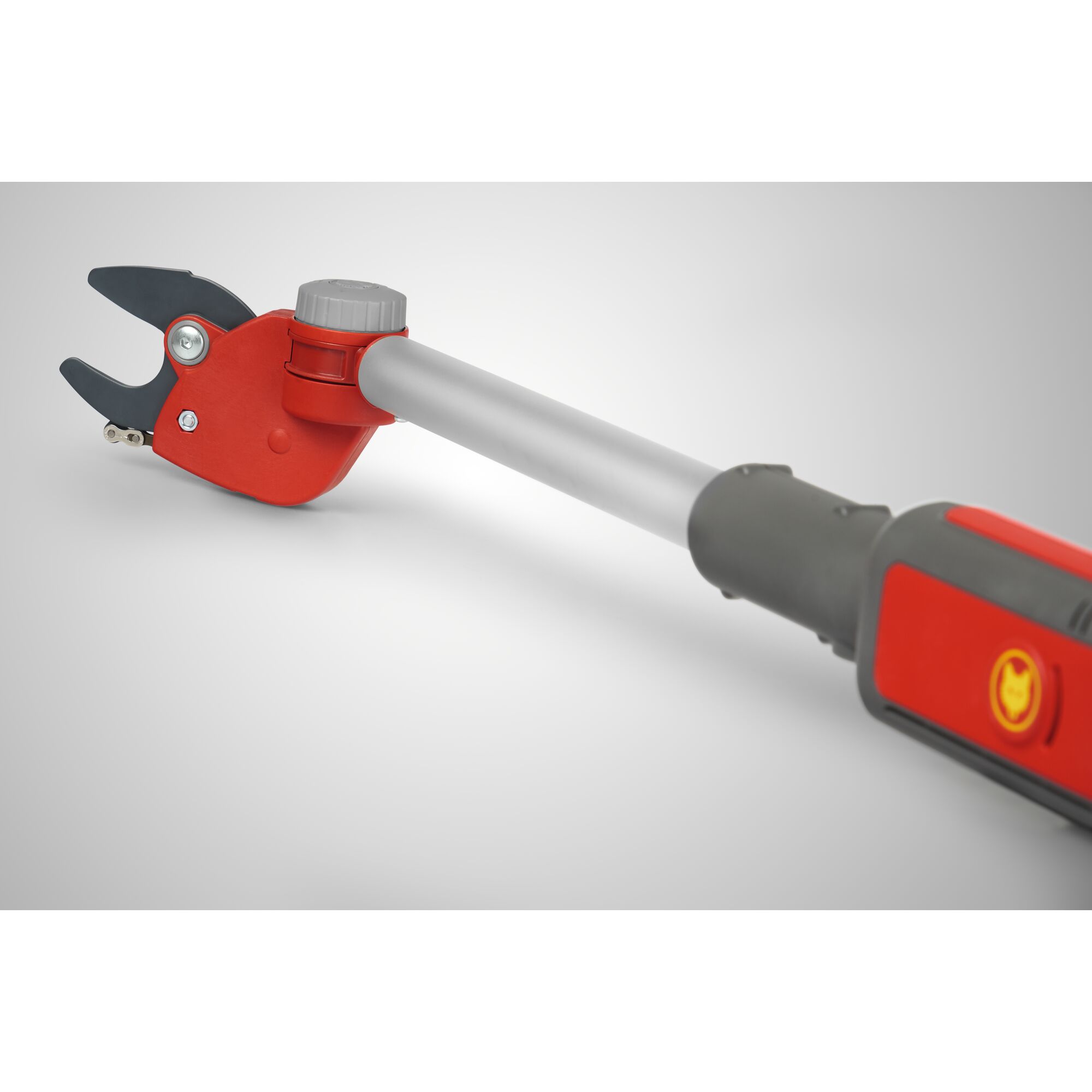 Close-up image of a WOLFGarten telescopic lopper with a red and grey handle and adjustable cutting head, suitable for gardening and tree pruning.