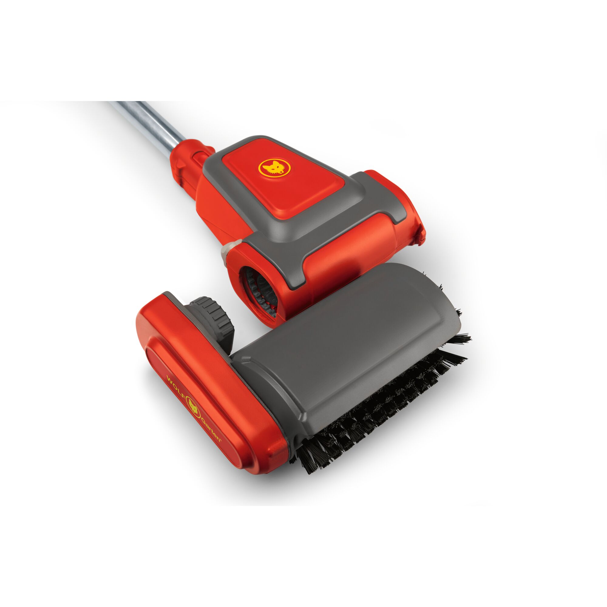 A close-up of a WOLFGarten cleaning brush attachment, featuring a red and grey design and sturdy bristles, intended for use with a handle or pole.
