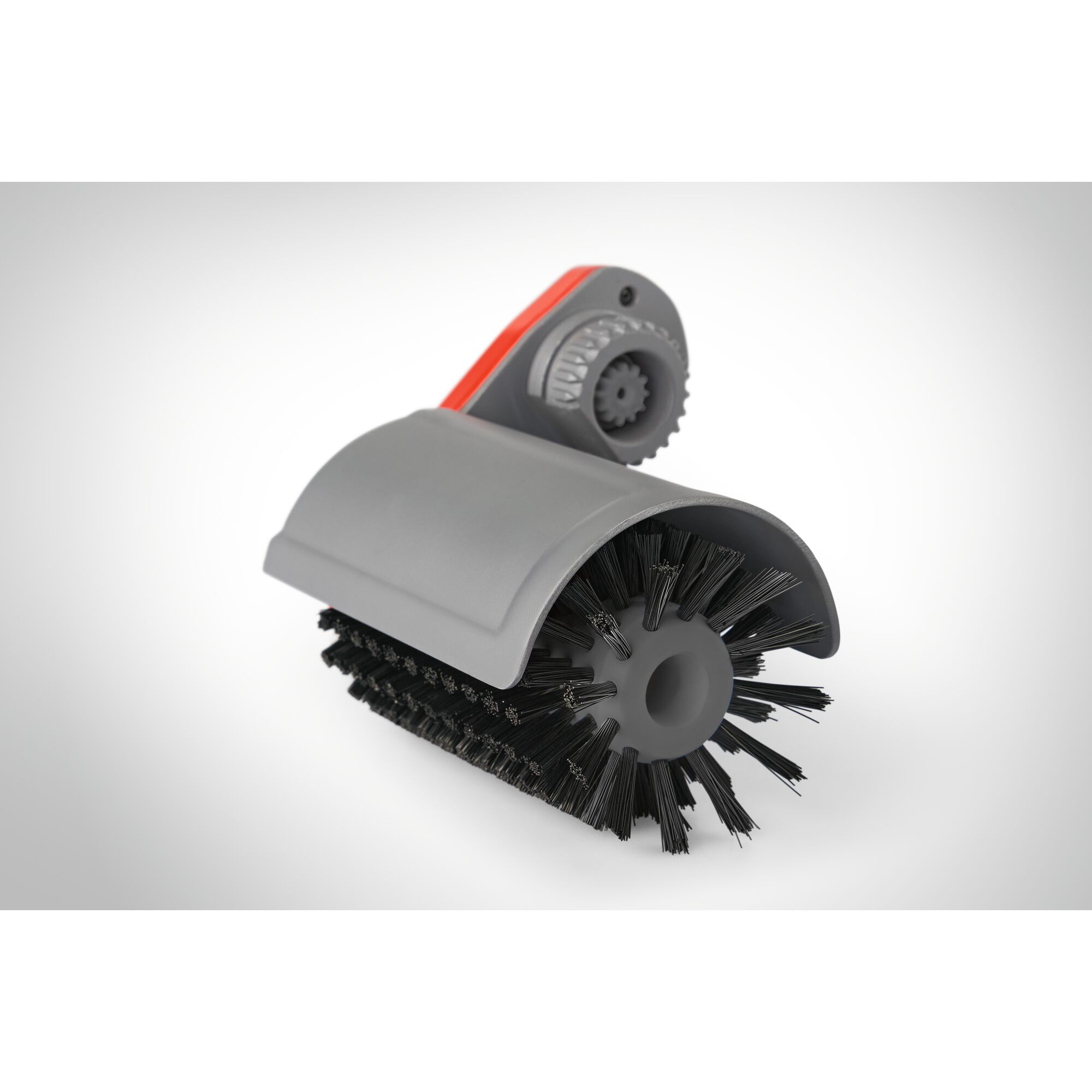 A close-up image of a WOLFGarten garden tool attachment with black bristles and a grey plastic cover, used for cleaning and brushing surfaces.