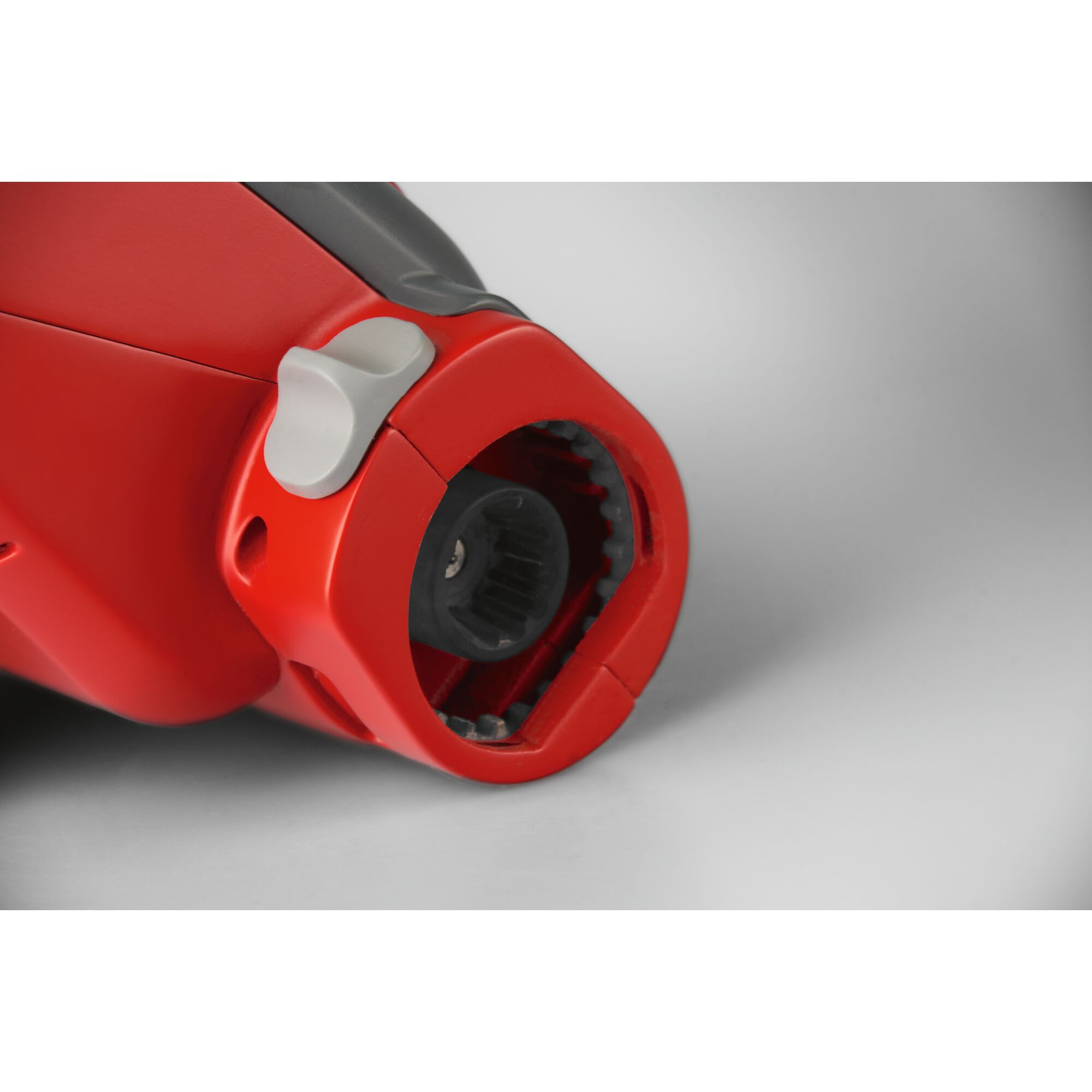 Close-up view of a red and black WOLFGarten gardening tool connector, showing the detailed locking mechanism.