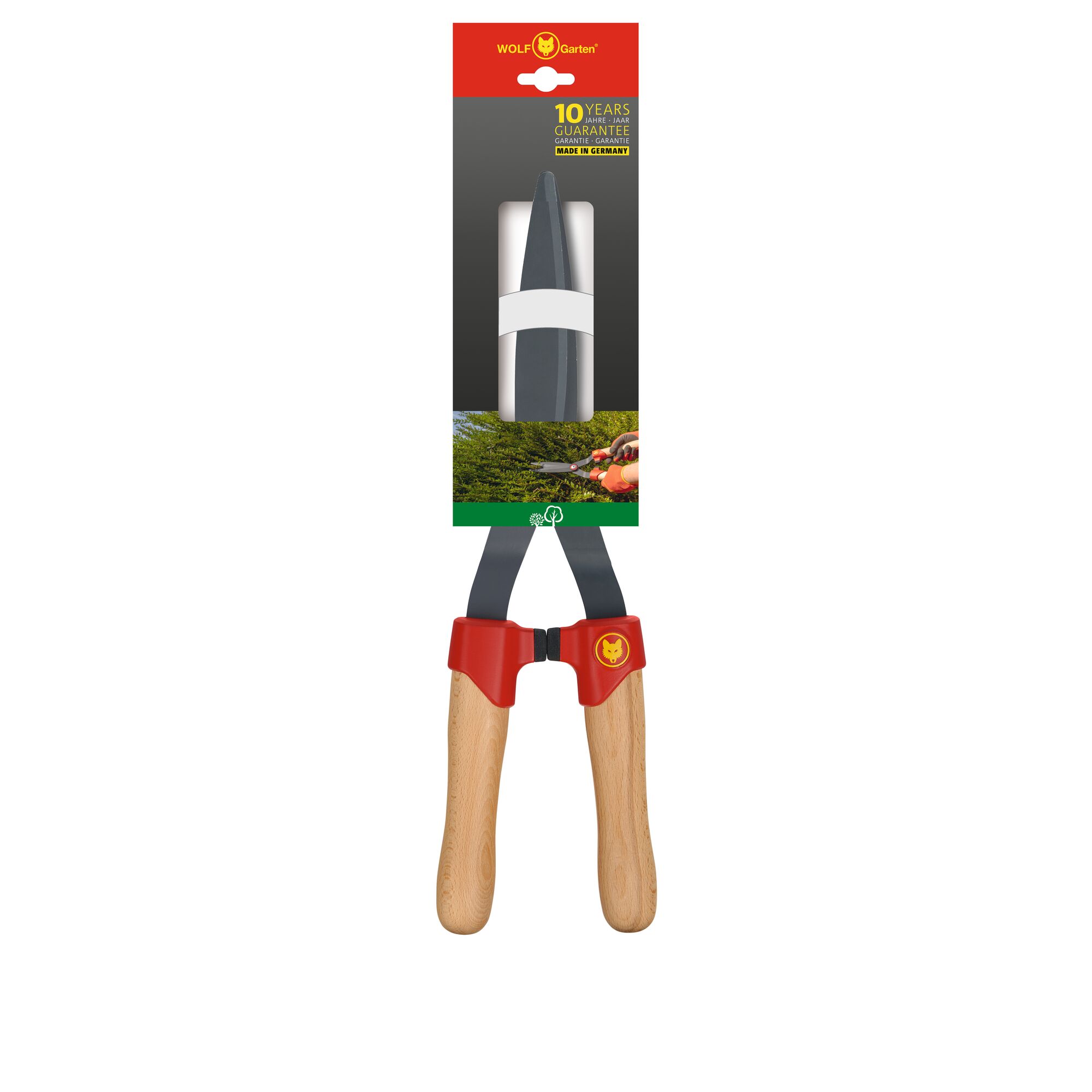 WOLF Garten hedge shears with wooden handles and red accents, shown in its retail packaging. The packaging highlights a 10-year guarantee and the product is made in Germany.