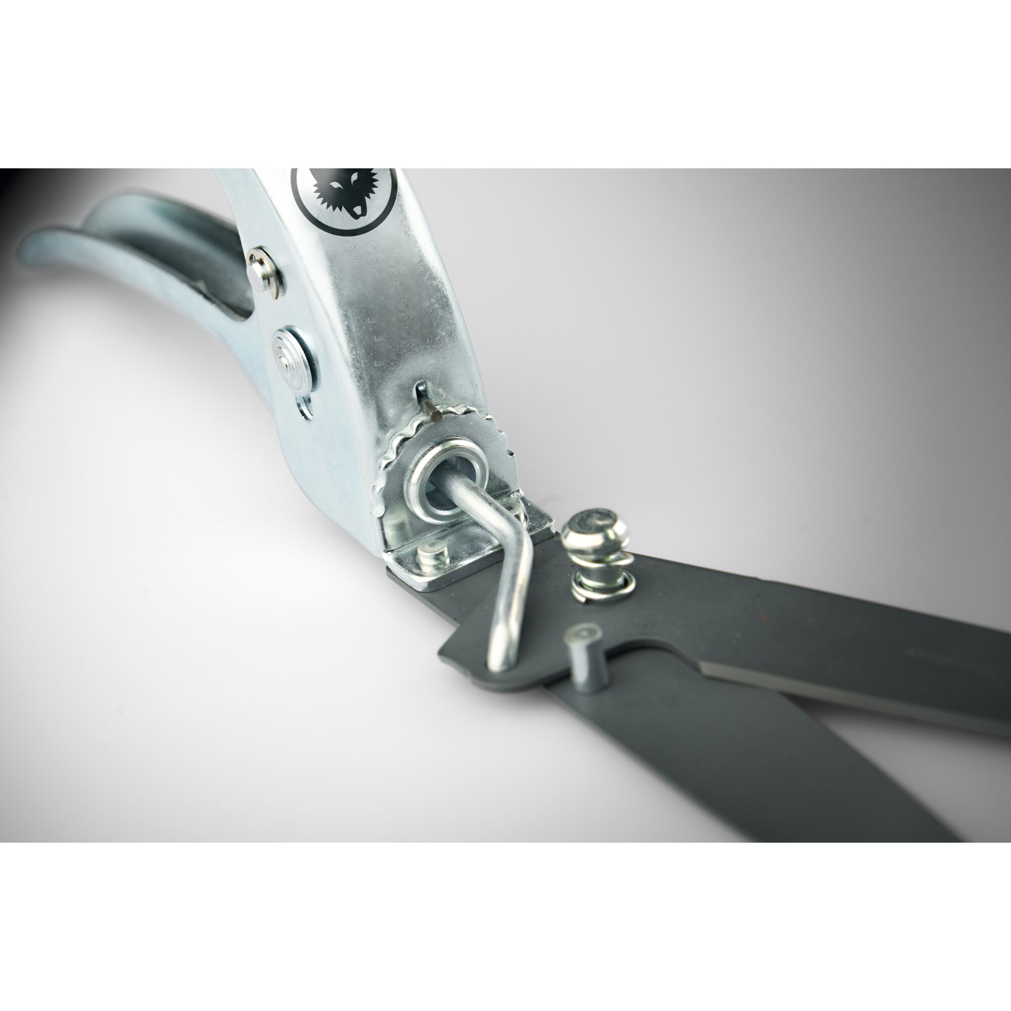 Close-up of a metal garden shear with an adjustable mechanism and black blades.