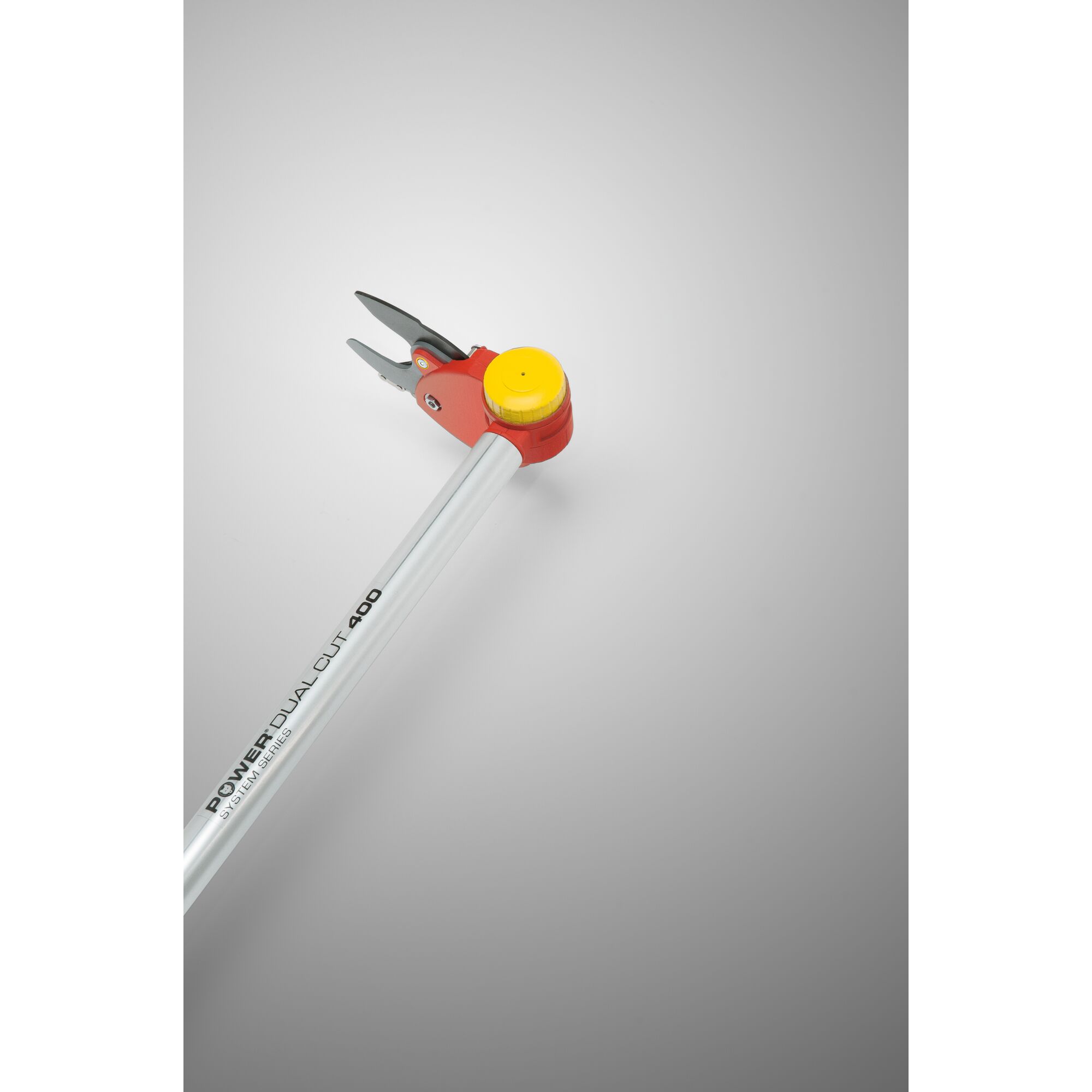 A close-up photo of a WOLFGarten Power Dual Cut 400 pruning tool with a silver handle, red and yellow head, and sharp cutting blades, displayed against a neutral background.