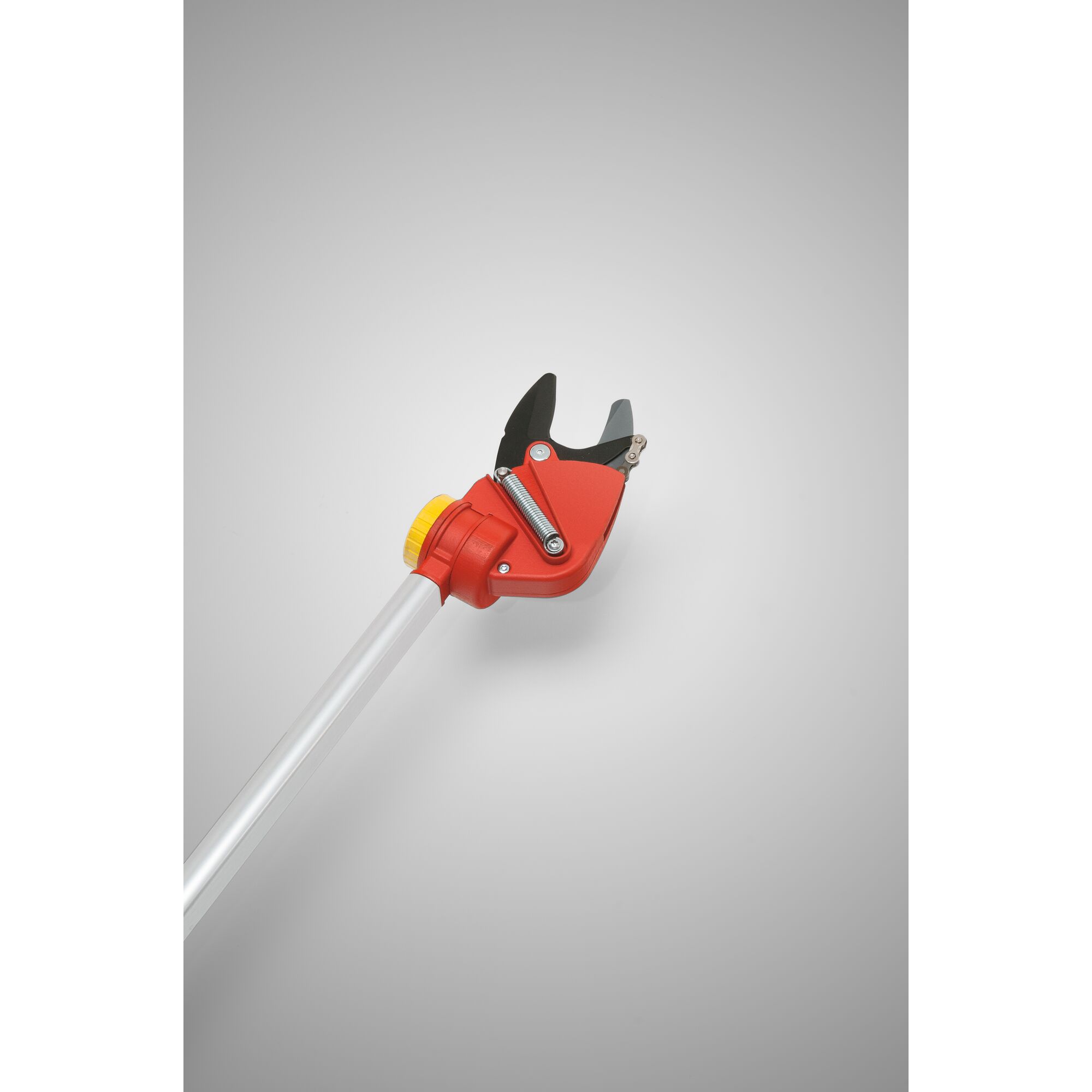 A close-up image of a WOLFGarten garden lopper with a red and yellow handle and black blade, designed for pruning branches and plants.