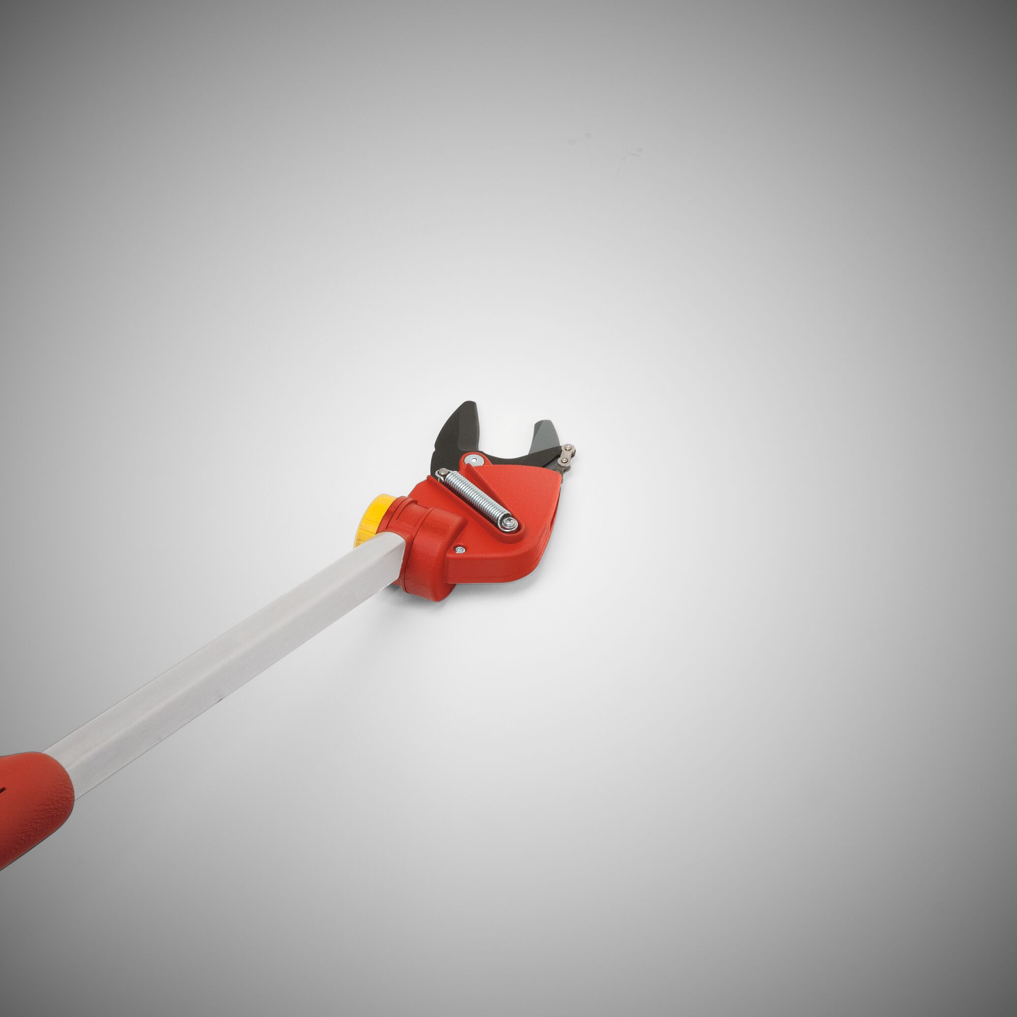 A close-up image of a red and yellow garden lopper with a long silver handle, used for pruning branches, against a plain grey background.
