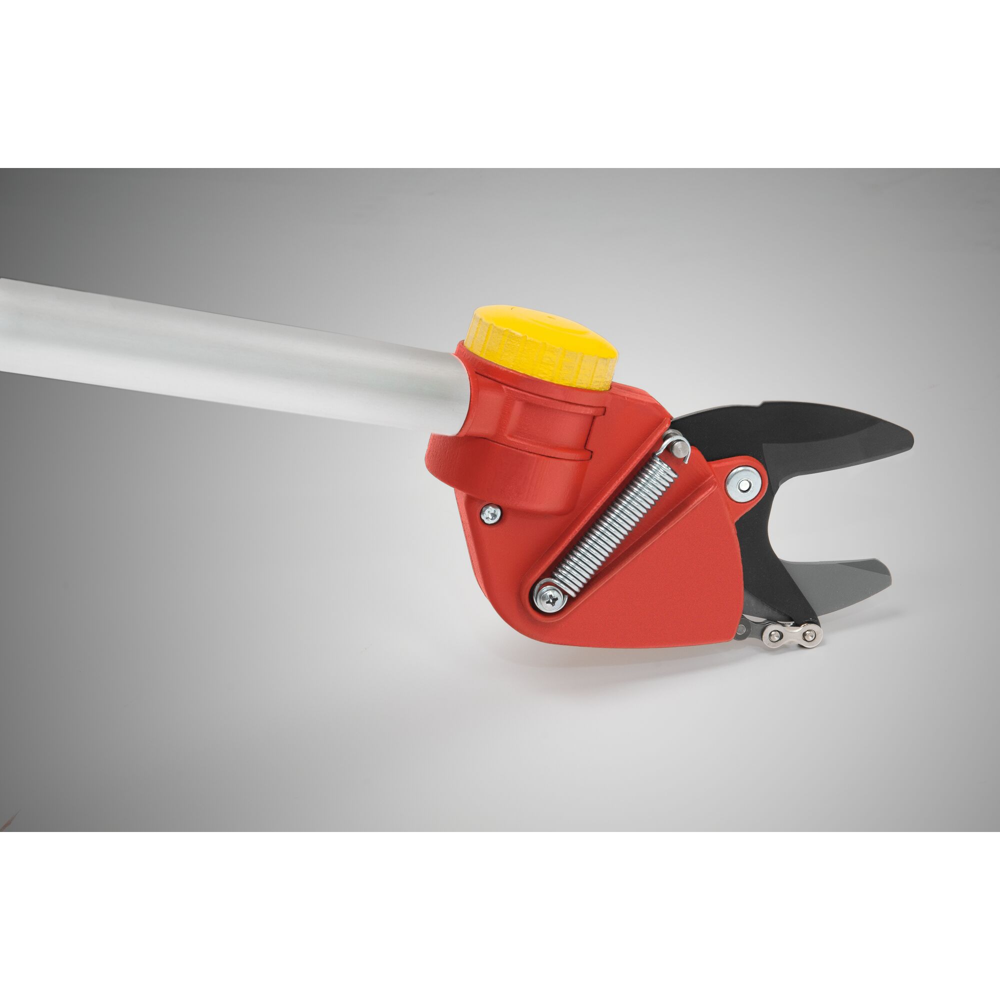 Close-up of a red and yellow garden pruner with a silver handle, featuring a spring mechanism and sharp black blades. The pruner is set against a neutral grey background.