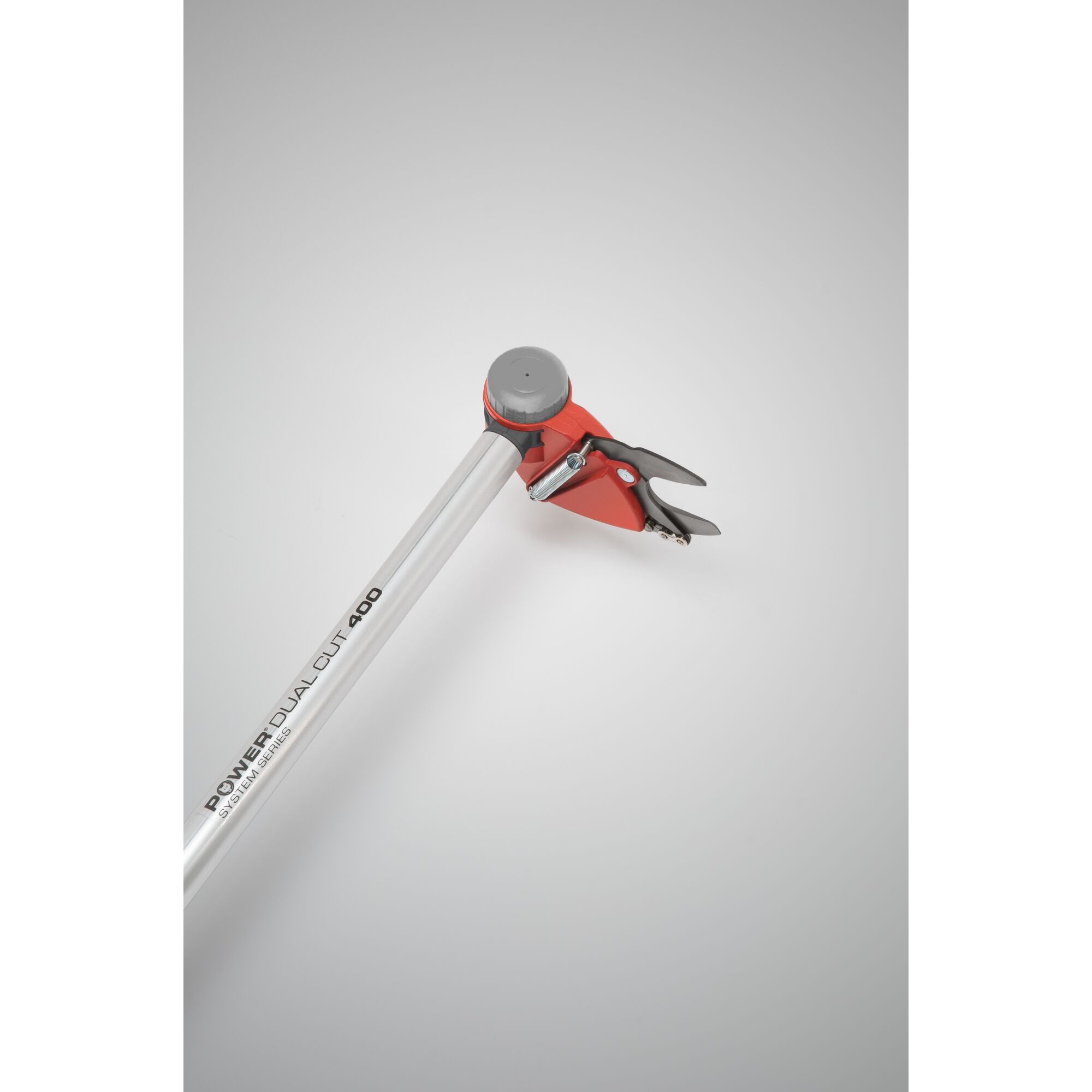 A close-up photo of a WOLFGarten Power Dual Cut 400 pruning tool featuring a silver handle and red cutting head with black and silver blades, used for garden or tree pruning.