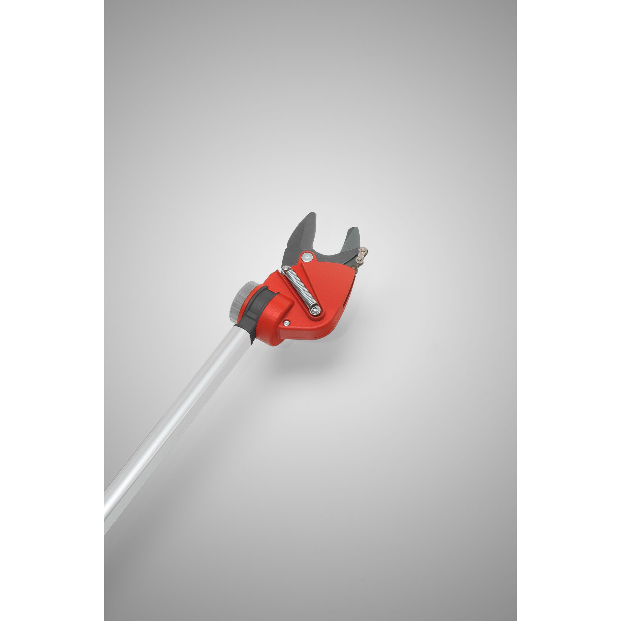 A red and black pruning tool with a long silver handle, designed for cutting branches, photographed against a plain gray background.