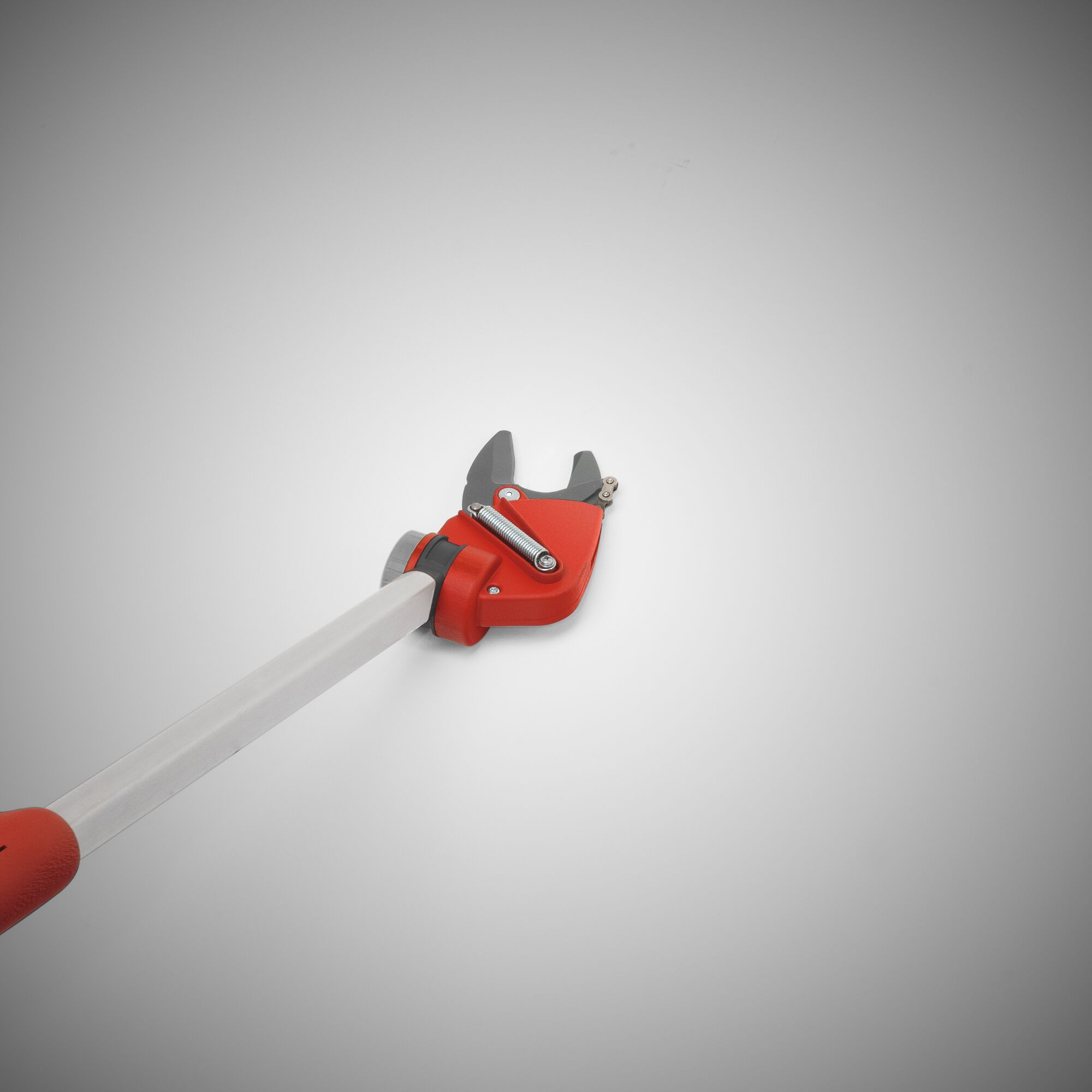 A close-up image of a red and silver long-handled garden pruner with bypass blades, designed for cutting branches at height.