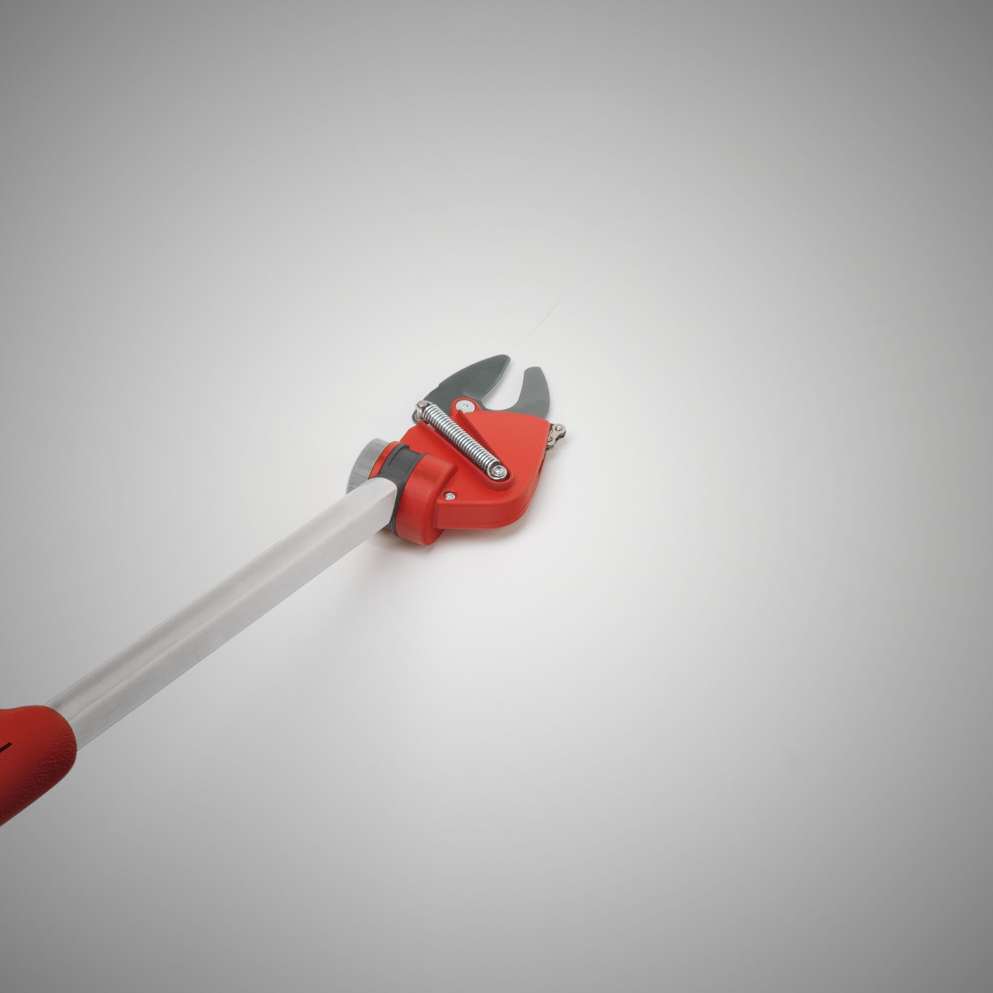 A close-up image of a long-handled, red and silver garden lopper, designed for cutting branches, shown against a plain light background.