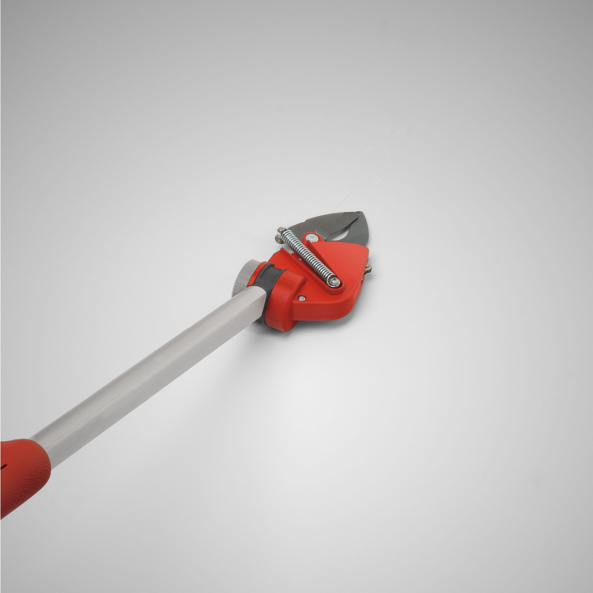 A close-up image of a WOLFGarten long-handled garden pruner with a red and silver design, featuring a cutting blade and spring mechanism, placed on a neutral background.